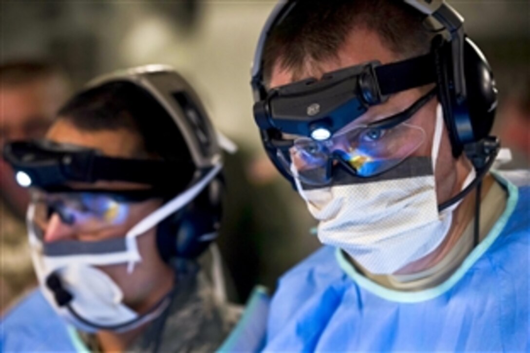U.S. Air Force Lt. Col. Gerald Fortuna performs a simulated exploratory laparotomy surgery while aboard a C-17 Globemaster III aircraft during a field exercise at the Joint Readiness Training Center on Fort Polk, La., Jan. 17, 2014. Fortuna, a trauma surgeon, is assigned to the 86th Medical Group, Ramstein Air Base, Germany.