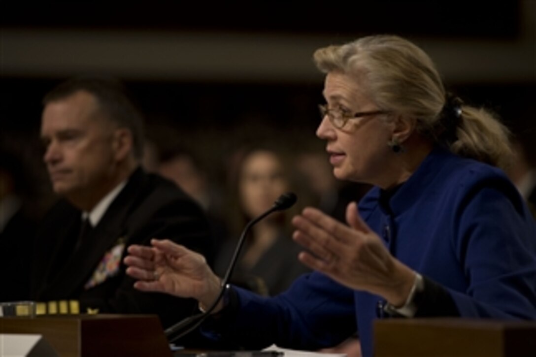 Acting Deputy Defense Secretary Christine H. Fox answers a question as Navy Adm. James A. Winnefeld Jr., vice chairman of the Joint Chiefs of Staff, listens during testimony before the Senate Armed Services Committee in Washington, D.C., Jan. 28, 2014. Fox and Winnefeld addressed the current budget environment and the possible requirement to slow the rate of growth in military compensation.