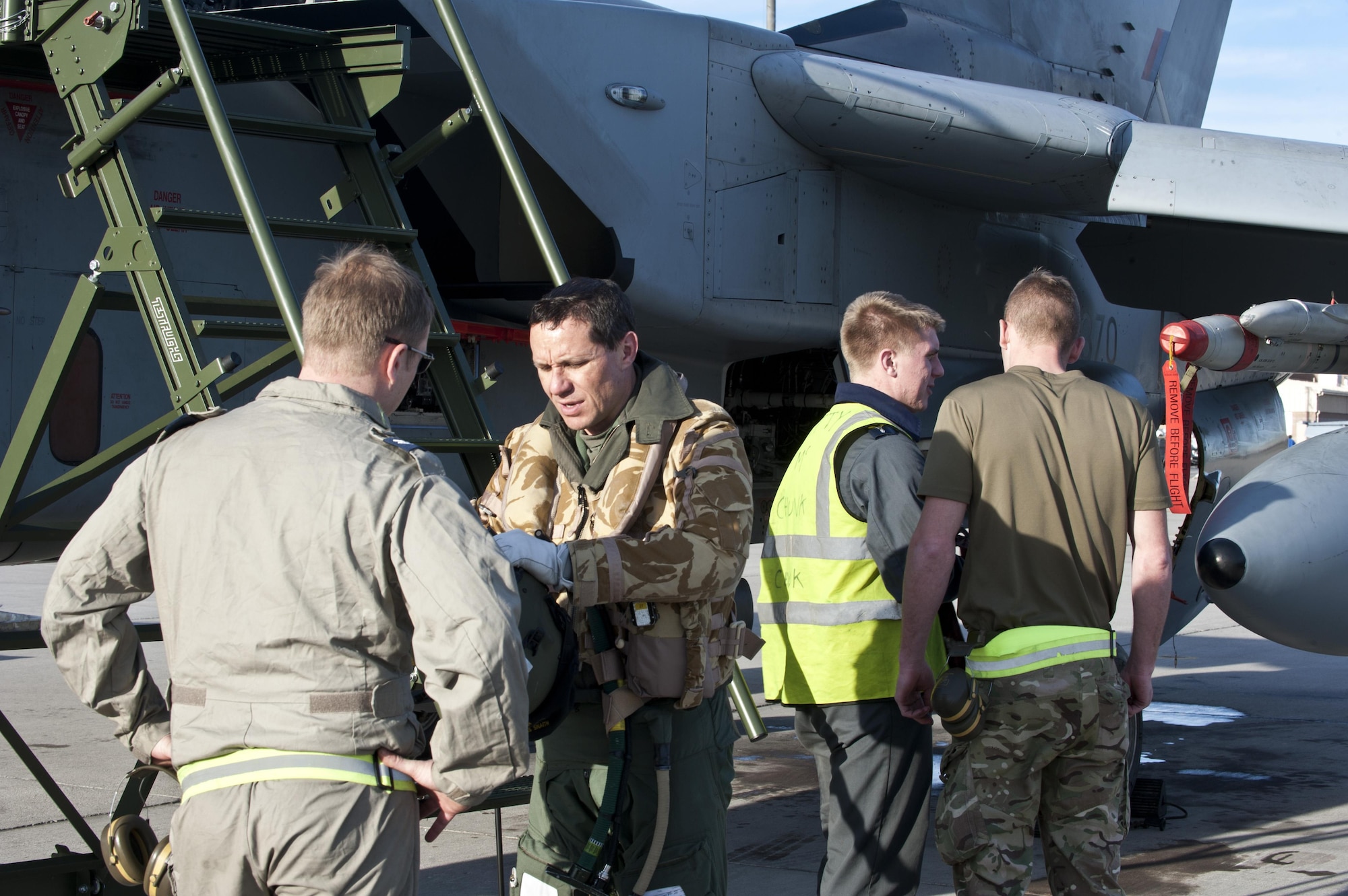 Royal Air Force Corporal Steve Pascoe talks to a pilot about a GR4 Tornado during Red Flag 14-1 Jan. 27, 2014, at Nellis Air Force Base, Nev. Red Flag gives aircrew and air support operators from various airframes, military services and allied countries an opportunity to integrate and practice combat operations. Pascoe is an IX (B) Squadron mechanical engineer from RAF Marham, United Kingdom. (U.S. Air Force photo/Senior Airman Matthew Lancaster)
 