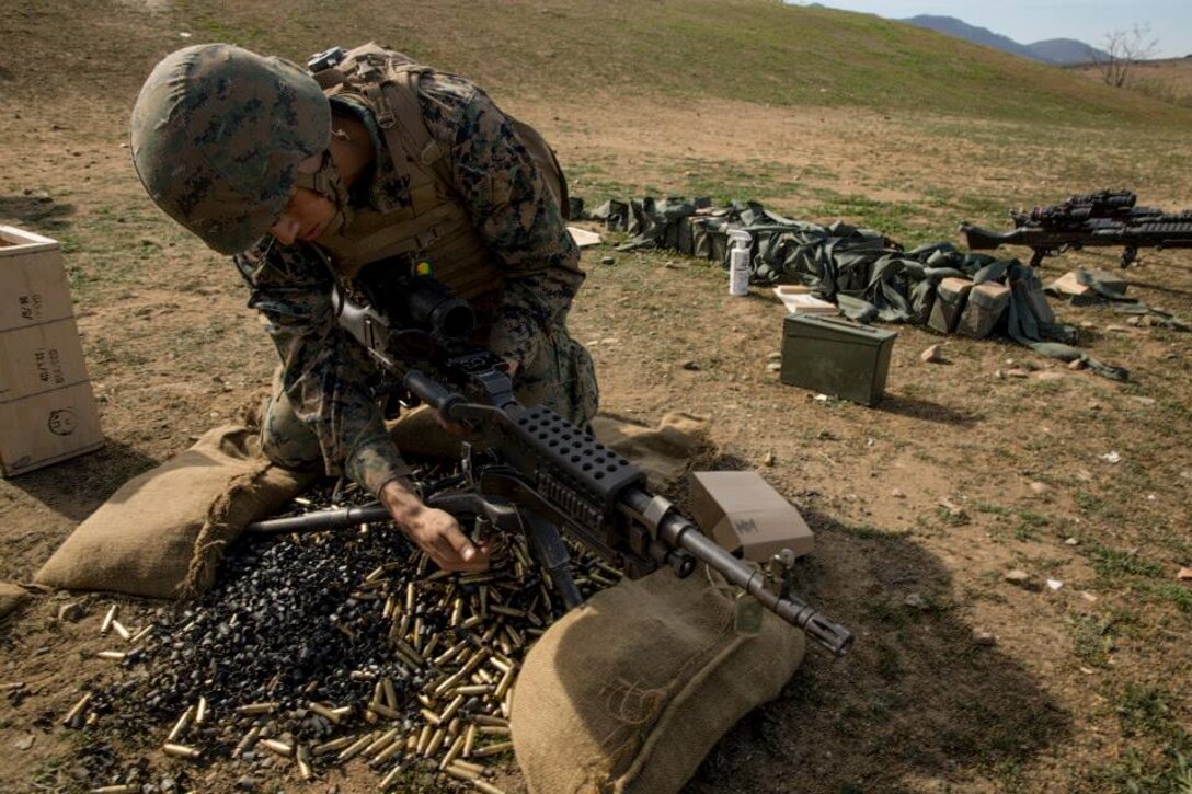 Pfc. Oscar Saenz begins to take down an M240B machine gun on range 218A in the 53-area of Camp Pendleton on Jan. 28. Saenz is training to be a 0331 machine gunner with Delta Company, Infantry Training Battalion, School of Infantry-West. Saenz is from Mission, Texas and is 18. 

Infantry Training Battalion trains all infantry, entry-level Marines in the infantry skills essential to operating combat environment. Infantry Training Battalion is a 52-day training course that transforms the raw Marine into an infantryman who can fight, survive, and win in a combat situation.

