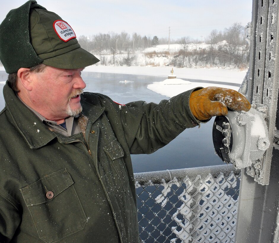 Jeff Kleinert, Pokegama Lake Recreation Area site supervisor, adjusts the gates at the Pokegama Dam in Grand Rapids, Minn., Jan. 23. Despite temperatures dropping below negative 20 degrees, U.S. Army Corps of Engineers, St. Paul District park rangers continue working to ensure the reservoir levels are maintained and the snow measurements are taken as the district continues preparations for a spring runoff. USACE photo by Patrick Moes