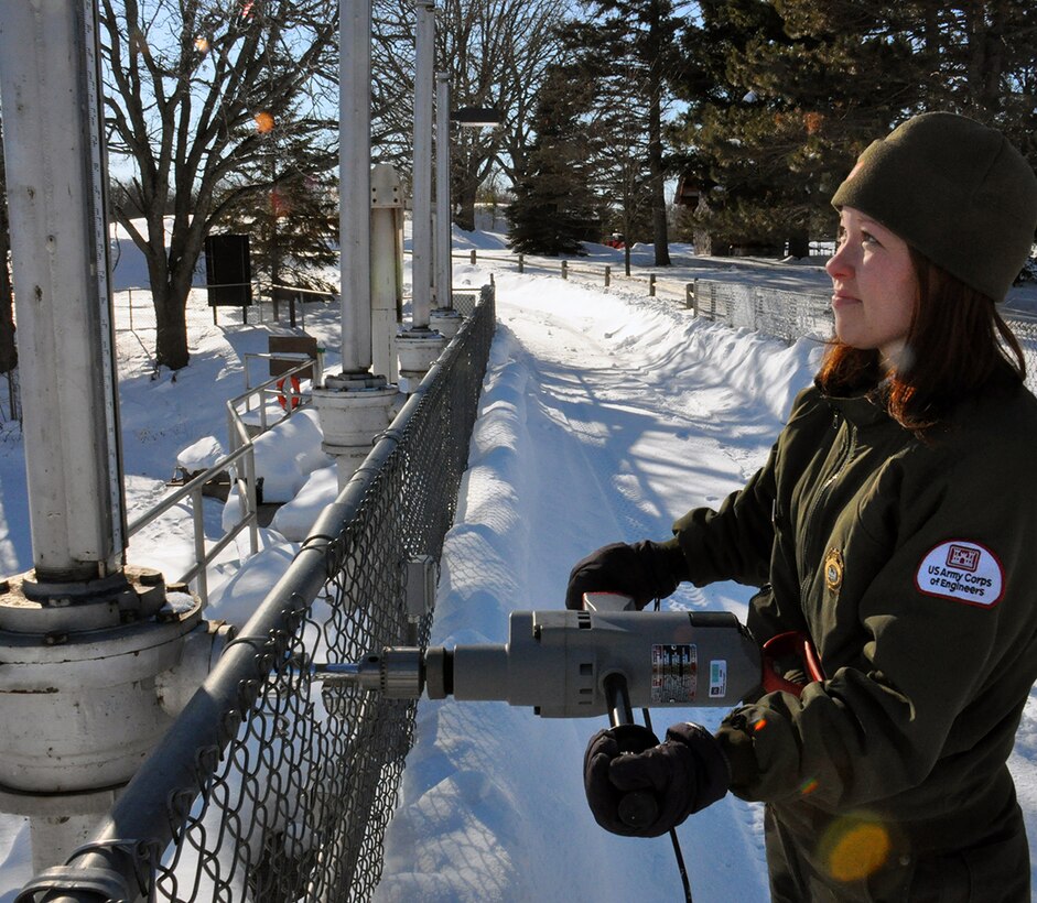 Tammy Johnson, Big Sandy Lake Recreation Area site supervisor, adjust the gates at the dam, near McGregor, Minn., Jan. 23. Despite temperatures dropping below negative 20 degrees, U.S. Army Corps of Engineers, St. Paul District park rangers continue working to ensure the reservoir levels are maintained as the district continues preparations for a spring runoff. 
