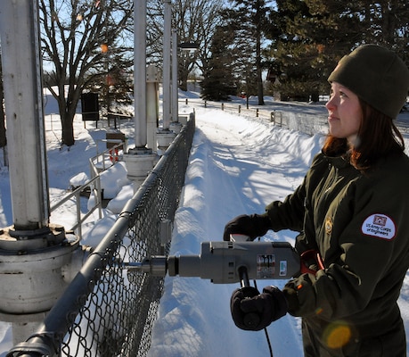 Tammy Johnson, Big Sandy Lake Recreation Area site supervisor, adjust the gates at the dam, near McGregor, Minn., Jan. 23. Despite temperatures dropping below negative 20 degrees, U.S. Army Corps of Engineers, St. Paul District park rangers continue working to ensure the reservoir levels are maintained as the district continues preparations for a spring runoff. 