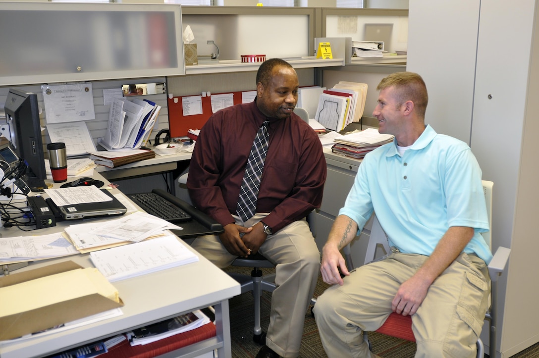 U.S. Army Corps of Engineers Nashville District employee Ray Kendrick, a Contracting Specialist explains procedures to Spc. Dustin Hobbs,  a service member working in the Operation Warfighter program.  Operation Warfighter is the first professional transition program active wounded warriors can experience and USACE’s Nashville District is applying it on a group scale. Nashville District partnered with Fort Campbell office where district personnel initiated an active recruiting campaign, interviewing wounded warriors at the base’s WTU for OWF intern positions. (USACE Photo by Mark A. Rankin)  