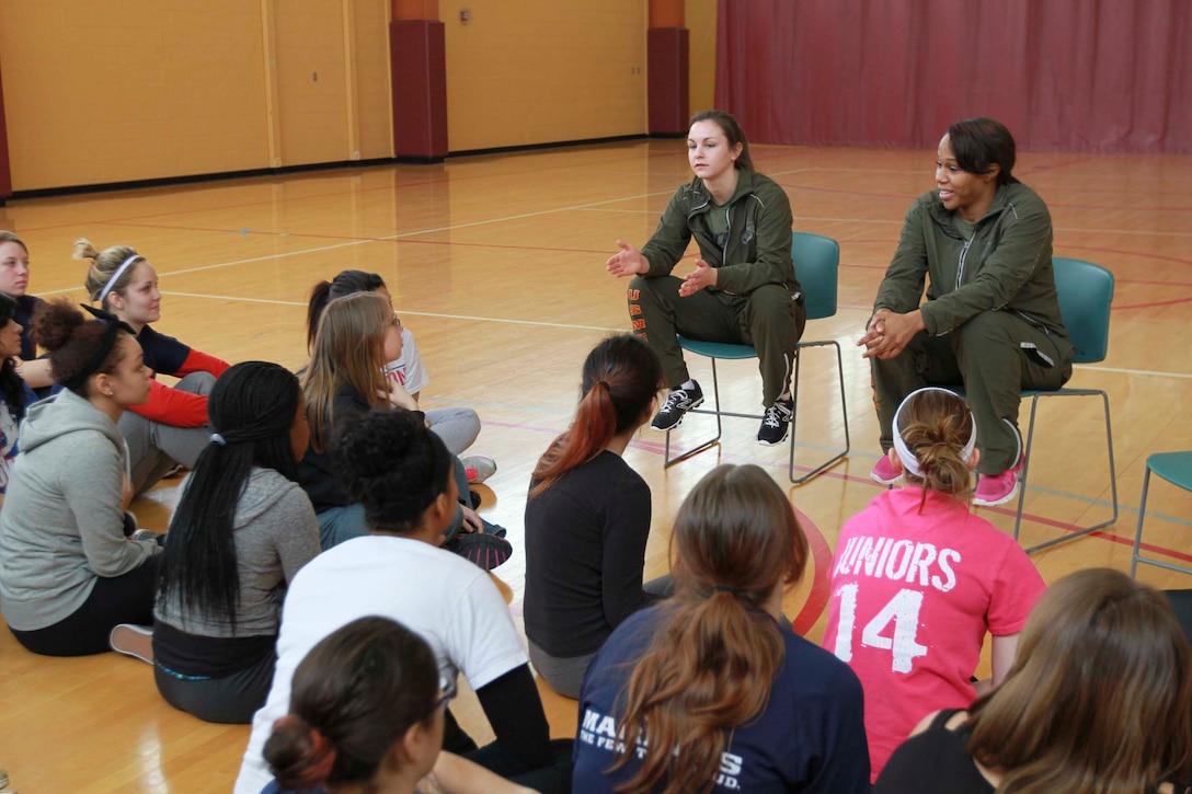 U.S. Marine Corps Pfc. Alena Gijsbers, left, and U.S. Marine Corps Sgt. Monique Smith, right, speak to pool members and guests during a female pool function in Romulus, Mich., Jan. 18, 2014. The event was held to build camaraderie and spread knowledge about the Marine Corps. Gijsbers is on recruiter’s assistance with Recruiting Sub-Station Livonia, Mich. and Smith, who has served for seven years, is a logistics specialist with Recruiting Station Detroit. (Marine Corps photo by Sgt. Elyssa Quesada/Released)