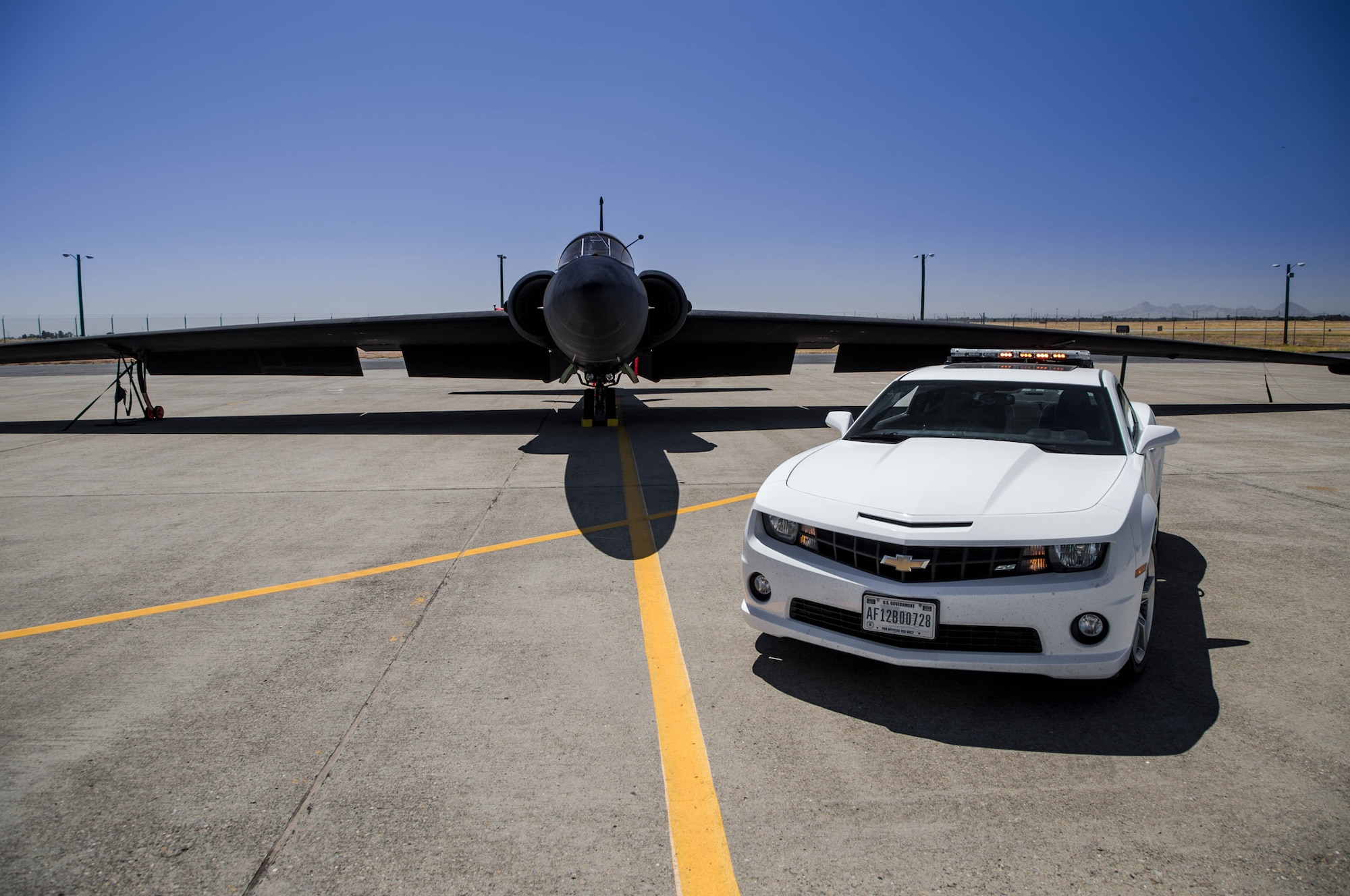 A Chevrolet Camaro SS sits in front of a U-2 Dragon Lady at Beale Air Force Base, Calif. Chase cars are used to help the Dragon Lady land safely. (Courtesy photo by Brain Vance of Motor Trend Magazine) 