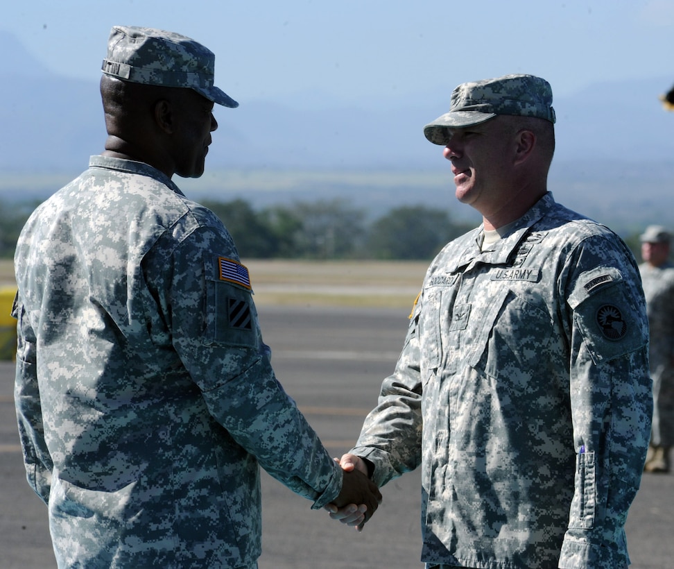 U.S. Army Col. Thomas Boccardi, Joint Task Force-Bravo Commander, shakes the hand of Command Sgt. Maj. Valmond A. Martin during a retirement ceremony conducted for Command Sgt. Maj. Martin at Soto Cano Air Base, Honduras, Jan. 29, 2014. Martin has served in the U.S. Army for more than 31 years. (Photo by Martin Chahin)