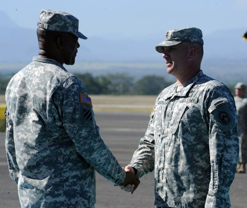 U.S. Army Col. Thomas Boccardi, Joint Task Force-Bravo Commander, shakes the hand of Command Sgt. Maj. Valmond A. Martin during a retirement ceremony conducted for Command Sgt. Maj. Martin at Soto Cano Air Base, Honduras, Jan. 29, 2014. Martin has served in the U.S. Army for more than 31 years. (Photo by Martin Chahin)
