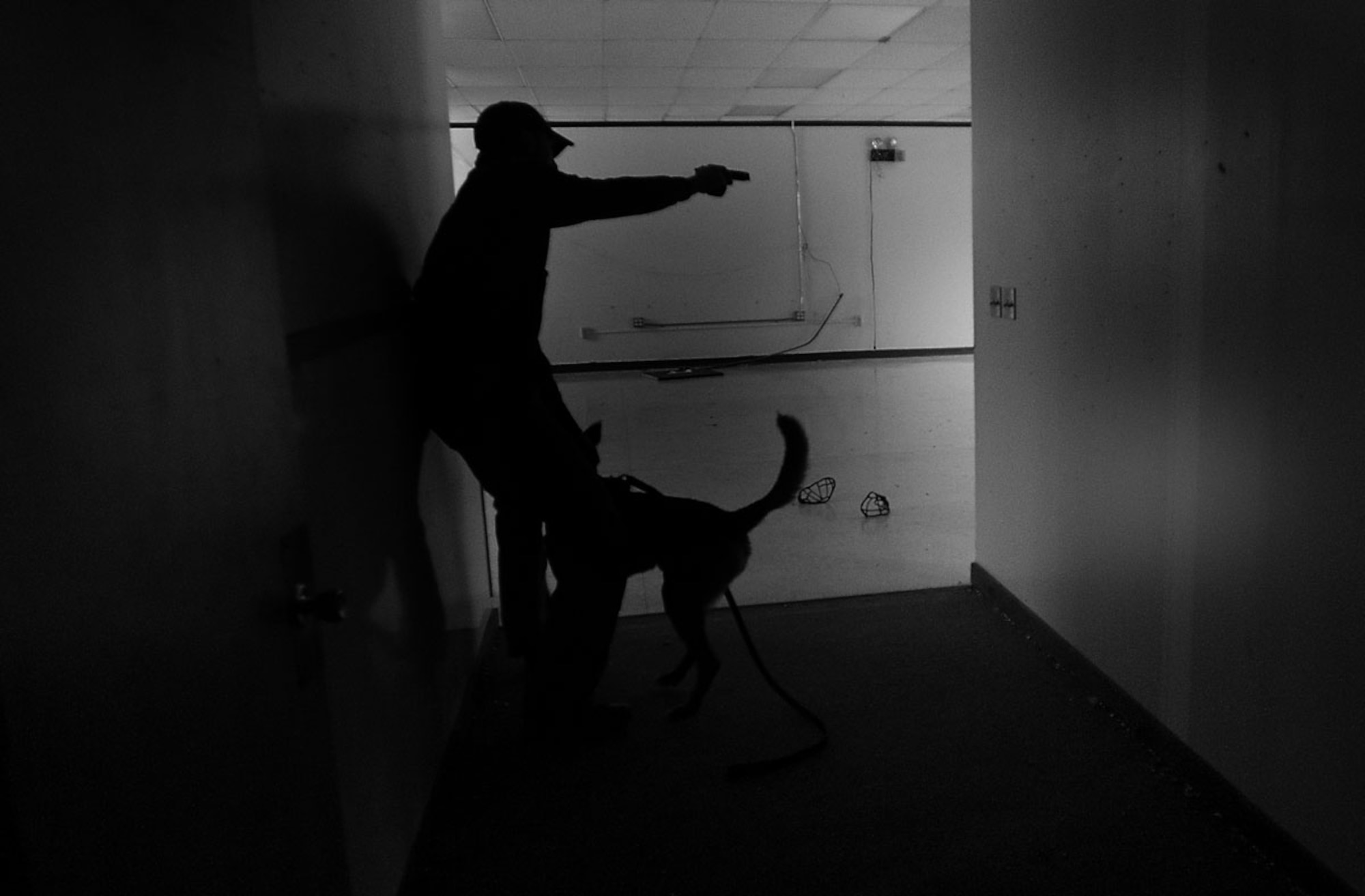 Air Force Staff Sgt. Joe Burns searches a building with his military working dog during a training session on Joint Base Elmendorf-Richardson, Alaska, Jan. 23, 2014. Burns is a 673d Security Forces Squadron MWD handler and a native of Portland, Maine. (U.S. Air Force photo/Staff Sgt. Robert Barnett)