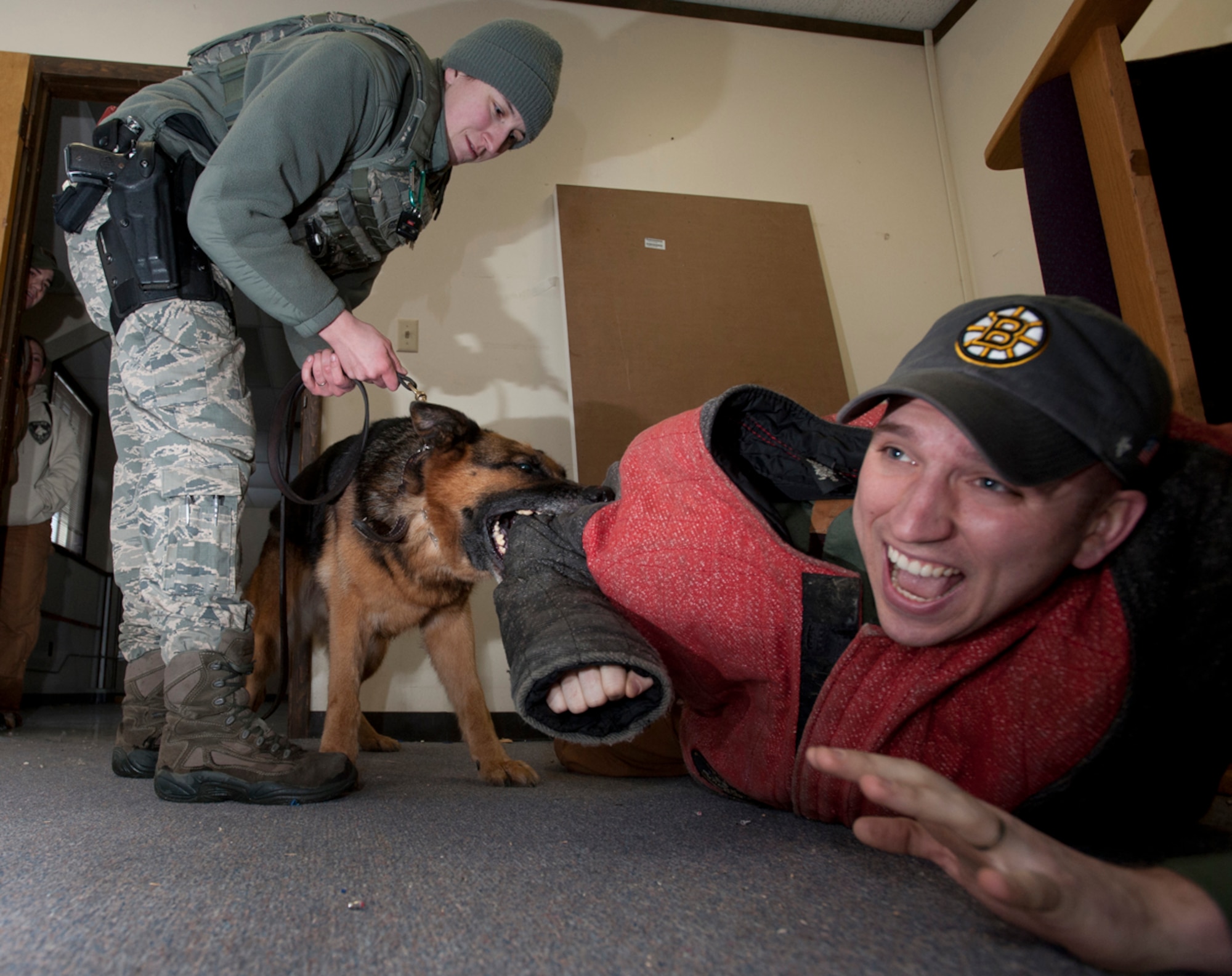 Air Force Staff Sgt. Rachel Mikesche pulls a military working dog off Air Force Staff Sgt. Joe Burns during training at Joint Base Elmendorf-Richardson, Alaska, Jan. 23, 2014. Mikesche and Burns are 673d Security Forces Squadron MWD handlers. Mikesche is from Jonesboro, Ga., and Burns is from Portland, Maine. (U.S. Air Force photo/Staff Sgt. Robert Barnett)