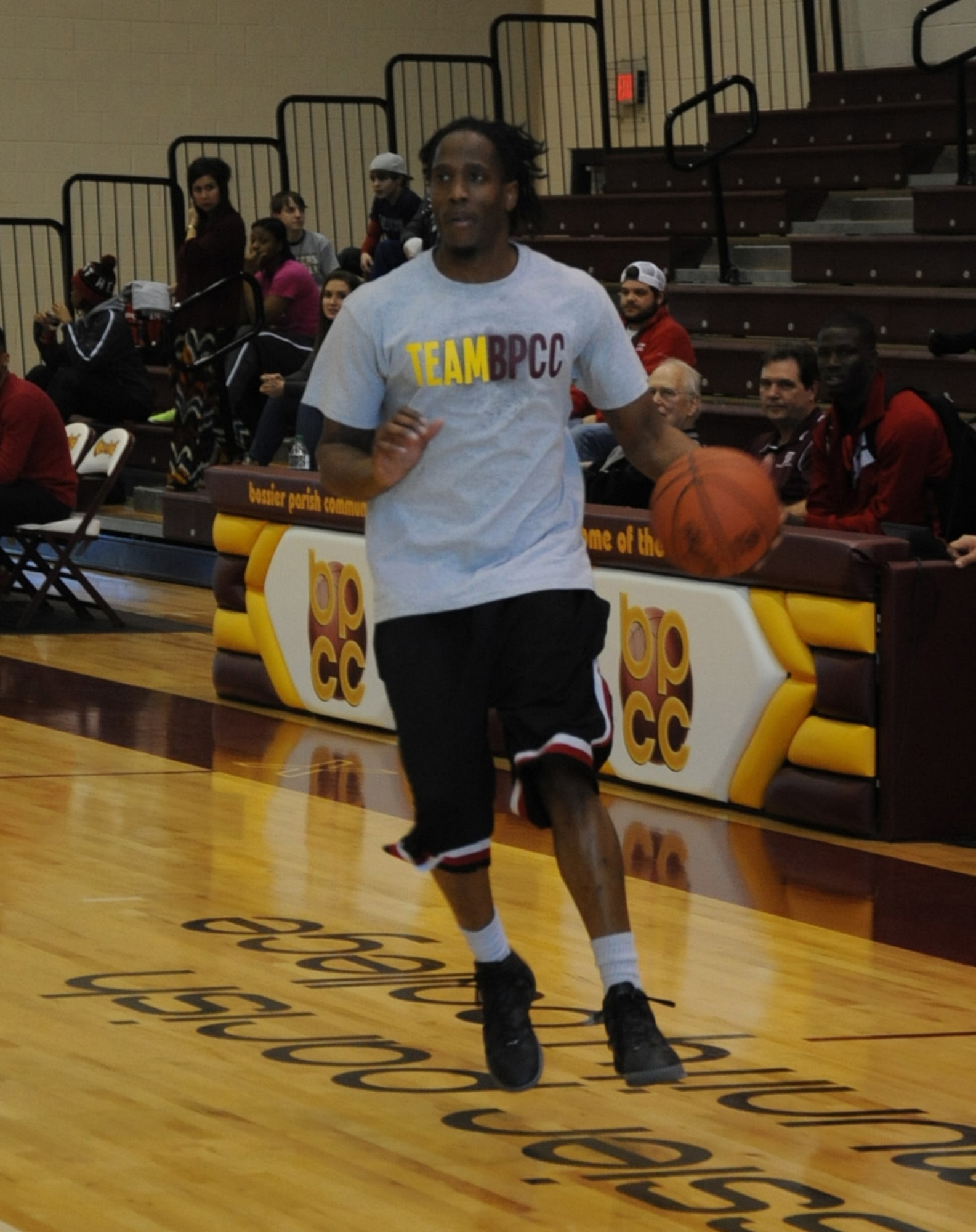 140125-F-SR682-099Brance Davenport, Bossier Parish Community College staff, dribbles down court during a military appreciation basketball game between Barksdale Air Force Base Airmen and Bossier Parish Community College faculty and staff at BPCC, Jan. 25, 2014. The game, which was the first of its kind, was a way for Barksdale and the local community to come together and show their support for one another. (U.S. Air Force photo/Staff Sgt. Sean Martin)