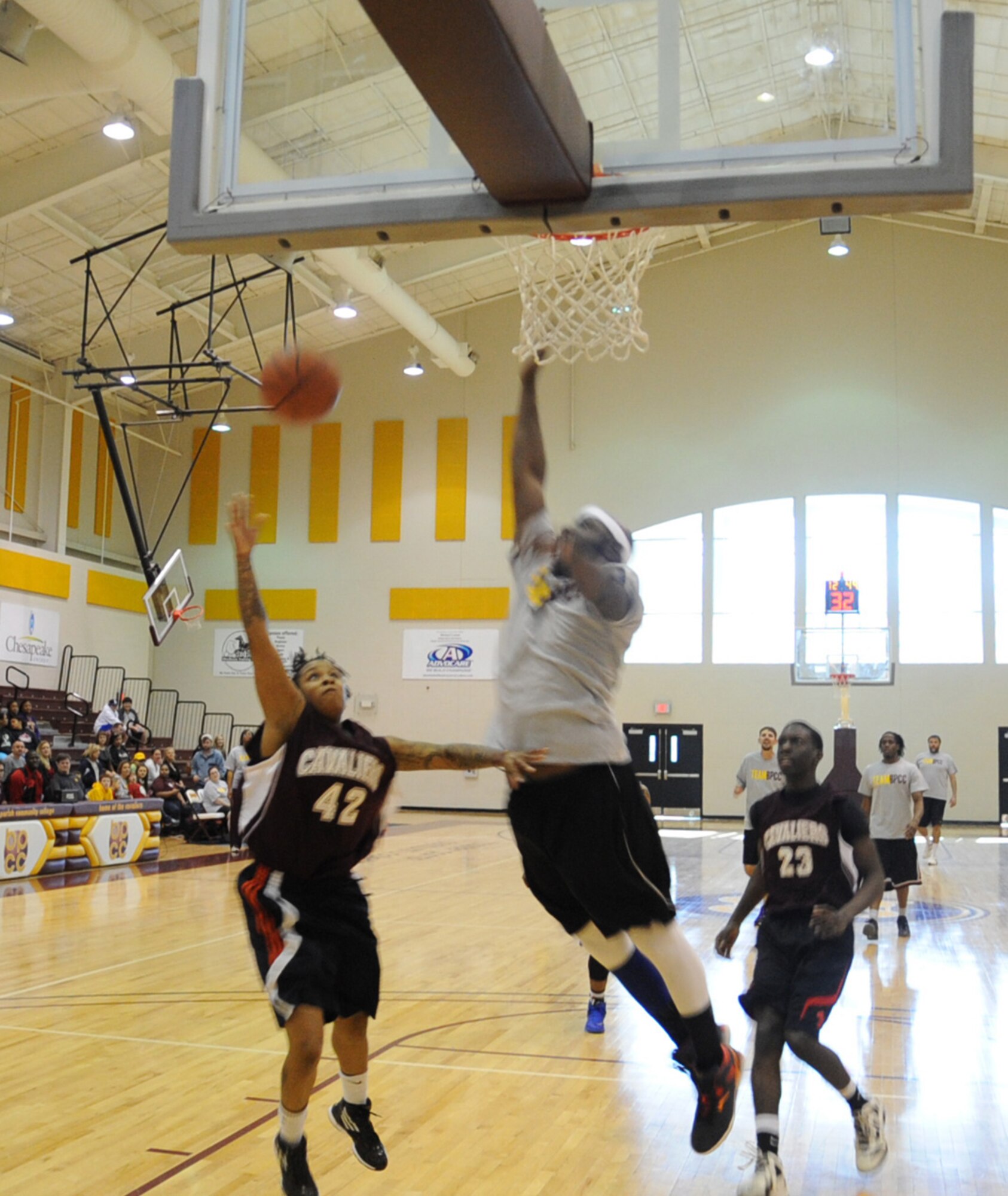 Airman 1st Class Toni Singletary, 2nd Maintenance Squadron,  goes for a lay-up during a military appreciation basketball game between Barksdale Air Force Base Airmen and Bossier Parish Community College faculty and staff at BPCC, Jan. 25, 2014.  The game, which was the first of its kind, was a way for Barksdale and the local community to come together and show their support for one another. (U.S. Air Force photo/Staff Sgt. Sean Martin)