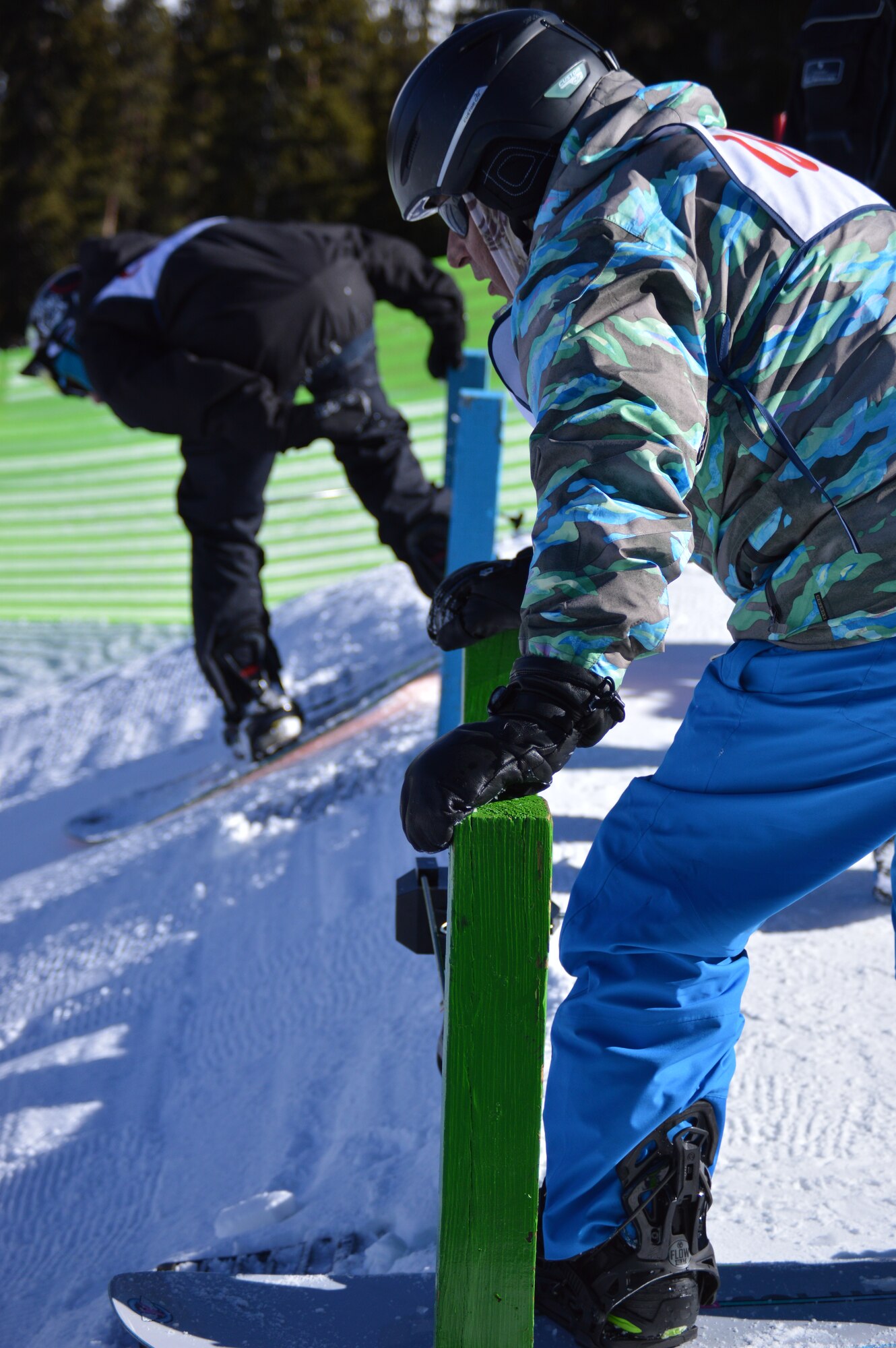 Patrick Young, 10th Force Support Squadron, prepares to shred down the snowboard course during the snowboard races at SnoFest Jan. 25. SnoFest participants had the opportunity to participate in ski, snowboard and cardboard derby races among other activities over the weekend. (U.S. Air Force Photo/Patrice Clarke)