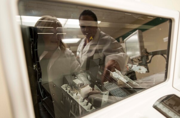 (from left to right) Lavon Slind, 5th Medical Group, Laboratory Technical Supervisor and Raquel Hoskin, 5th MDG medical laboratory technician test samples for blood abnormalities using a Vitros 350 Chemistry Analyzer at Minot Air Force Base, N.D. Jan. 23, 2014. Serious complications of strep throat, influenza and other diseases going untreated can be diagnosed using the broad spectrum of chemistry testing in the laboratory. (U.S. Air Force photo/Senior Airman Stephanie Sauberan)