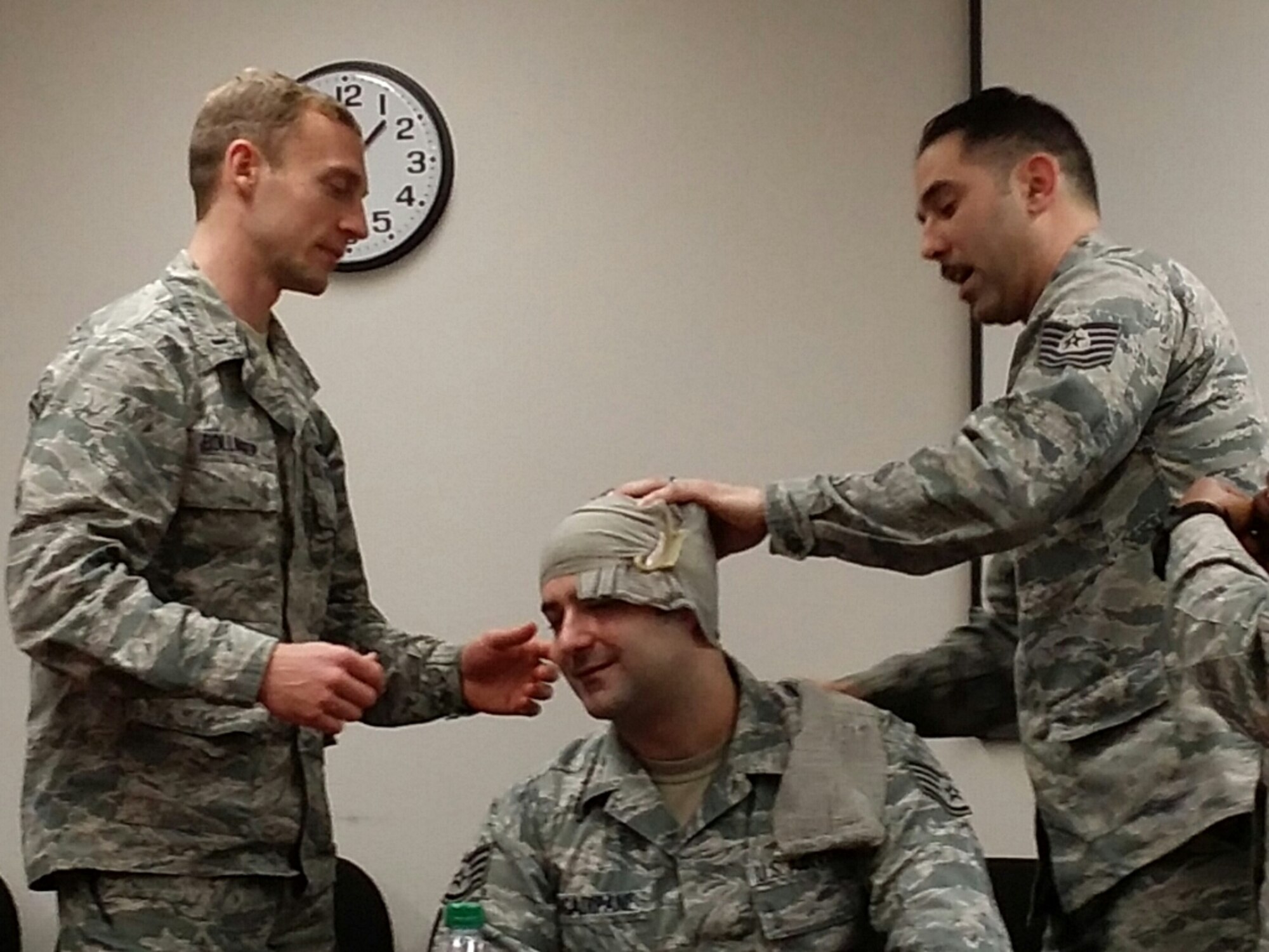 First Lt. Christopher Bollinger, Staff Sgt.Nicholas Arcadipane and Tech. Sgt. Juan Villa attend Self Aid Buddy Care training at Scott Air Force Base, Ill., Jan. 15. (U.S. Air Force photo/Master Sgt. Johnny Martinez)