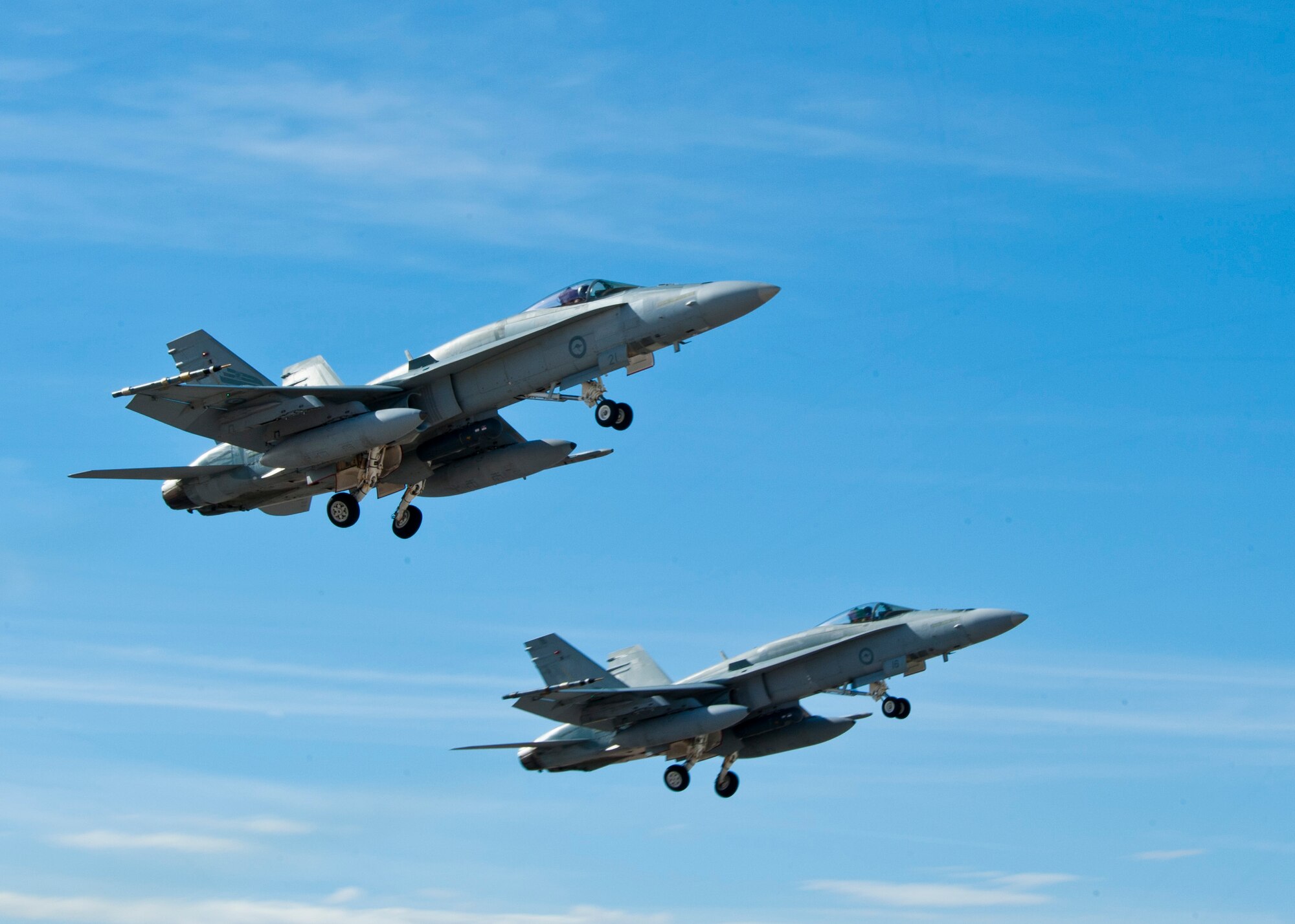 Two Royal Australian Air Force F/A-18 Hornets assigned to 77th Squadron take off during Red Flag 14-1 Jan. 28, 2014, at Nellis Air Force Base, Nev. Red Flag 14-1 is an air-to-air combat training exercise in the skies over the Nevada Test and Training Range. The purpose of the exercise is to increase the combat capability of U.S. and allied air forces for future combat situations. (U.S. Air Force photo by Airman 1st Class Jason Couillard)