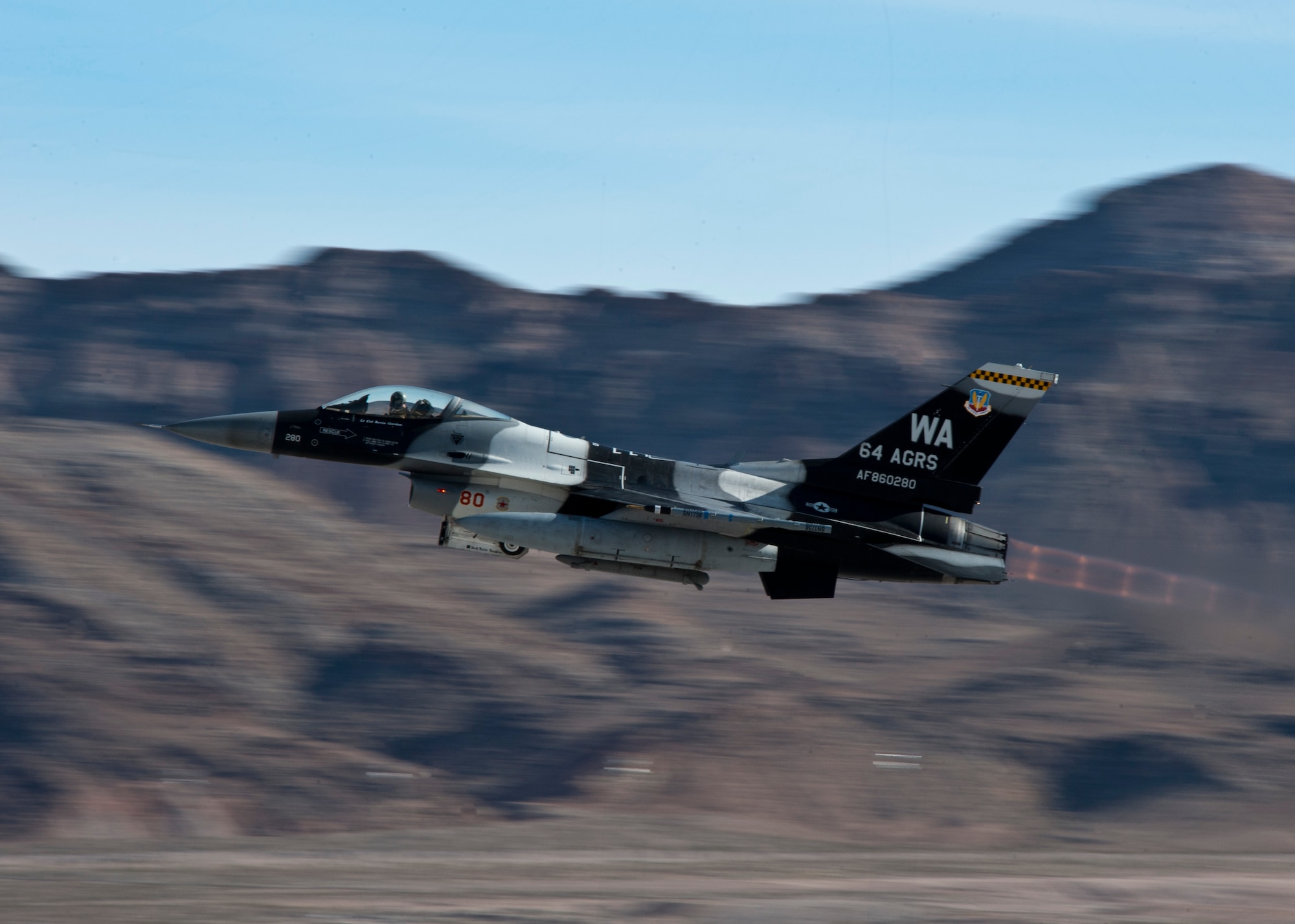 An F-16 Fighting Falcon assigned to the 64th Aggressors Squadron at Nellis Air Force Base, Nev. takes off during Red Flag 14-1 at Nellis AFB. The mission of the 414th Combat Training Squadron, the unit that plans and executes Red Flag, is to maximize the combat readiness and survivability of participants by providing a realistic training environment. There are approximately 125 aircraft participating in Red Flag 14-1. (U.S. Air Force photo by Airman 1st Class Jason Couillard)