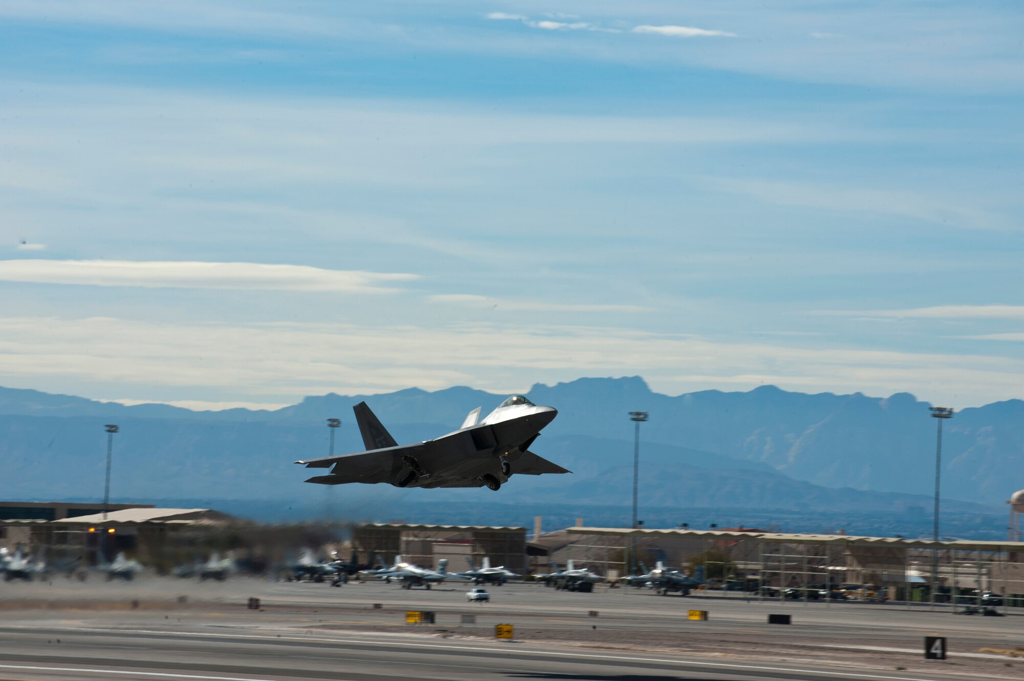 A U.S. Air Force F-22 Raptor assigned to Joint Base Langley-Eustis, Va., takes off during Red Flag 14-1 Jan. 28, 2014, at Nellis AFB, Nev. Red Flag Provides Airmen from U.S. and allied countries an opportunity to experience realistic combat scenarios to prepare and train in the event of future conflicts or war. The training exercise’s missions take place over the 2.9 million acre Nevada Test and Training Range. (U.S. Air Force photo by Airman 1st Class Thomas Spangler)