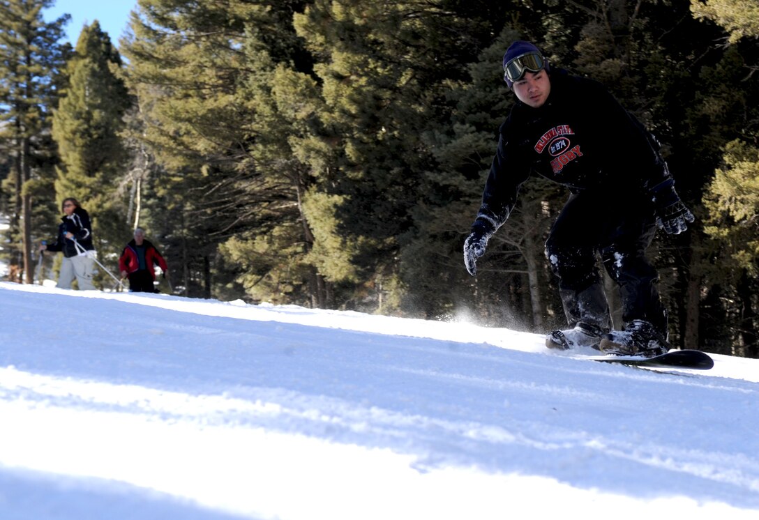 A snow-boarder swooshes down the hill Jan. 17, 2014 at Sipapu Ski and Summer Resort in Vadito, N.M. The Outdoor Recreation Center at Cannon Air Force Base, N.M., hosts trips throughout the year to ensure Airmen have the opportunity to experience all that New Mexico has to offer, from skiing and snowboarding in the winter to hiking and wine tasting in the summer. (U.S. Air Force photo/Senior Airman Ericka Engblom)