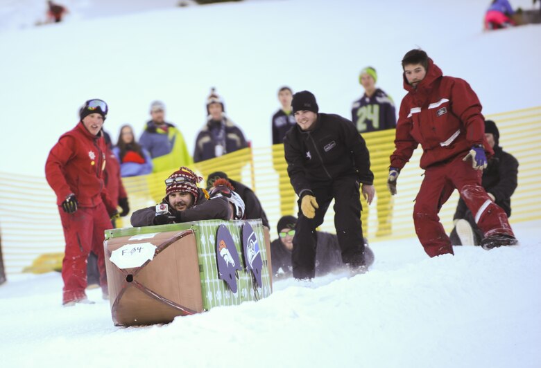 KEYSTONE, Colo. - Steven Sarandos, 50th Force Support Squadron commercial sponsorship coordinator, goes down the Discovery slope at Keystone Mountain during the SnoFest Cardboard Derby Jan. 25.  Almost 30 teams registered and competed in the derby, the fastest team cruised down the 75 yard slope in just longer than seven seconds. (U.S. Air Force photo/Staff Sgt. Jacob Morgan)