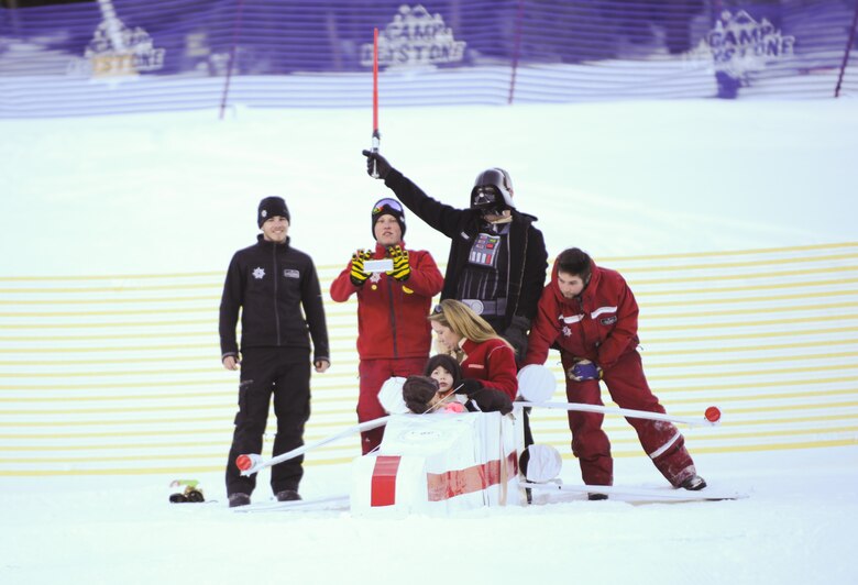 KEYSTONE, Colo. Lt. Col. Jason Terry, 52nd Airlift Squadron commander, dressed as Darth Vader, and his family prepare to slide down Discovery Slope of Keystone Mountain during the SnoFest Cardboard Derby Jan. 25. The Terry family competed in the family division against nine other craft and won the most creative trophy. (U.S. Air Force photo/Staff Sgt. Jacob Morgan)