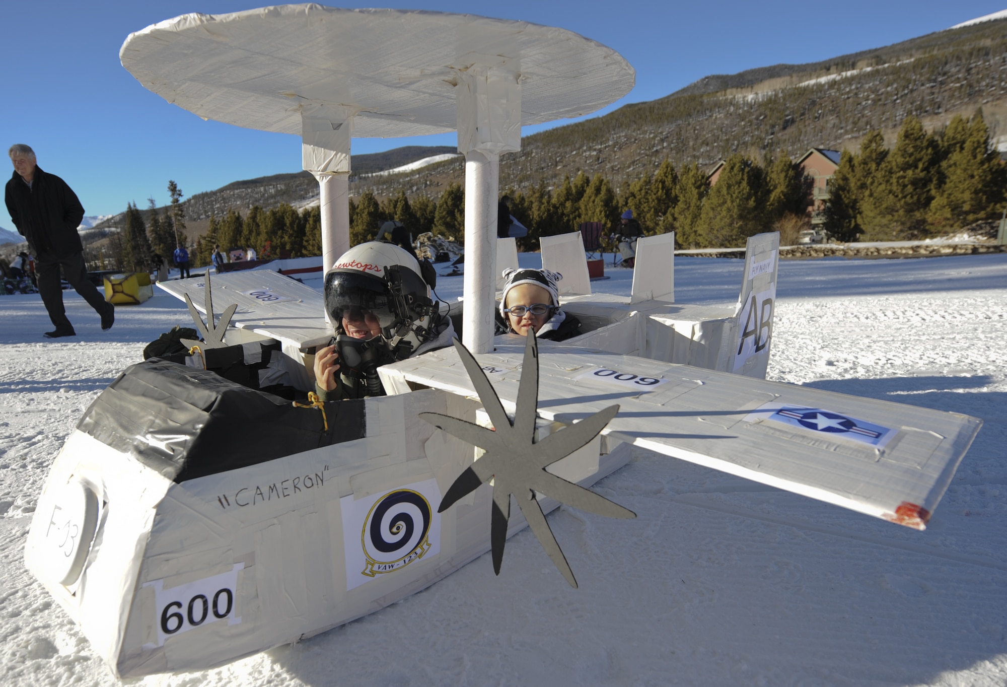 KEYSTONE, Colo. - Cameron and James Rybar, sons of Lt. Cmdr. Aaron Rybar, U.S. Navy, sit in a model E-2C Hawkeye just before the SnoFest Cardboard Derby on Discovery Slope at Keystone Mountain Jan. 25. The Rybar family competed against nine other craft in the family division. (U.S. Air Force photo/Staff Sgt. Jacob Morgan)