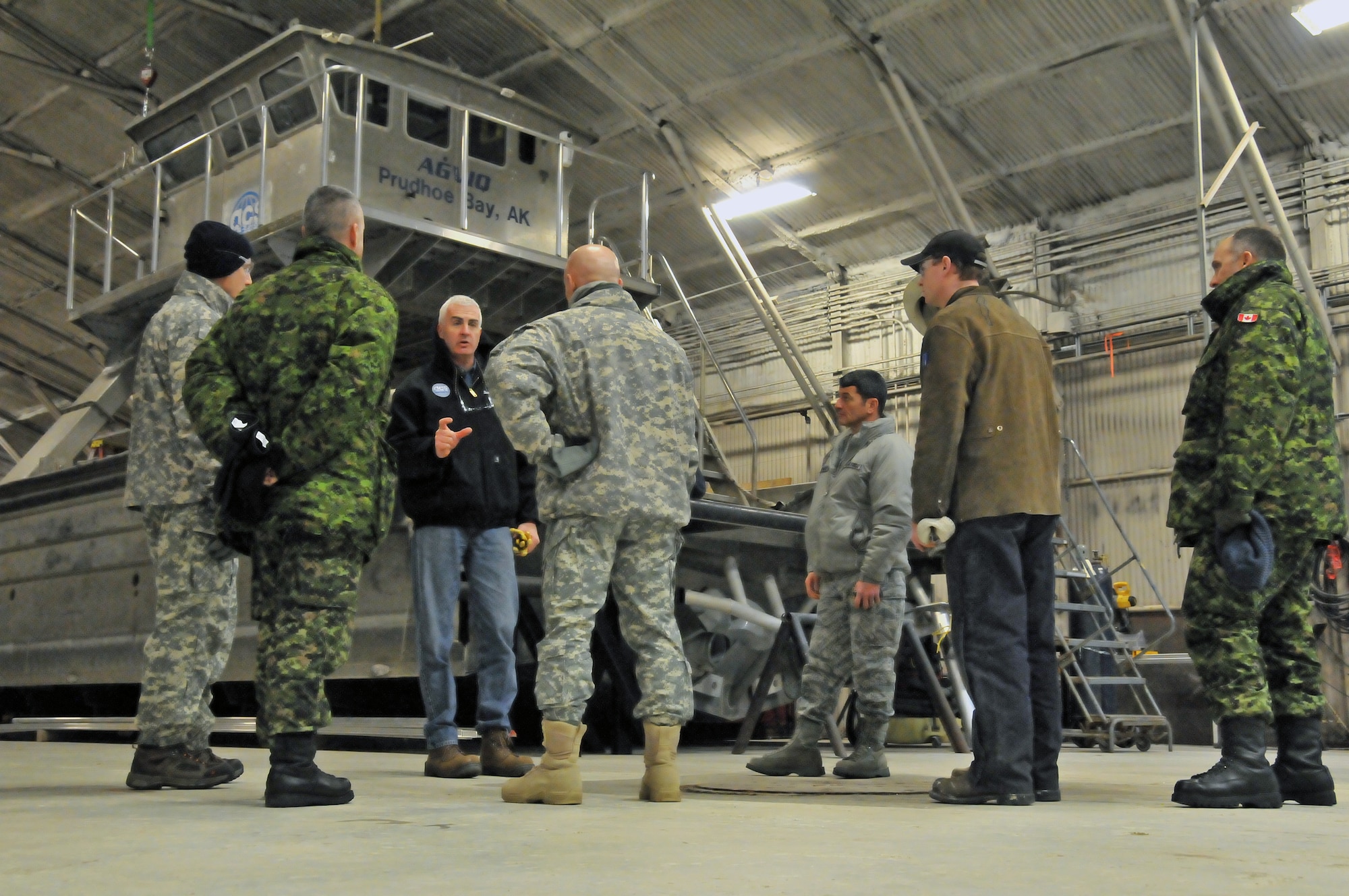 DEADHORSE, Alaska— C. Barkley Lloyd (middle left), Alaska Clean Seas president and general manager, discusses oil spill response resources and safety with conference attendees Jan. 9. Alaskan Command/Joint Task Force-Alaska and U.S. Army Alaska hosted a General Officer/Flag Officer Conference Jan. 7-11, which included distinguished guests from the U.S. Air Force, U.S. Army, Alaska National Guard, U.S. Coast Guard and Canadian Forces, to strengthen partnerships, discuss future Arctic challenges and joint capabilities. The GO/FO visited Deadhorse to tour ACS, which is an oil spill response cooperative whose membership includes companies that engage in oil and gas development on the North Slope of Alaska.  (U.S. Air Force photo/Tech. Sgt. John Gordinier)