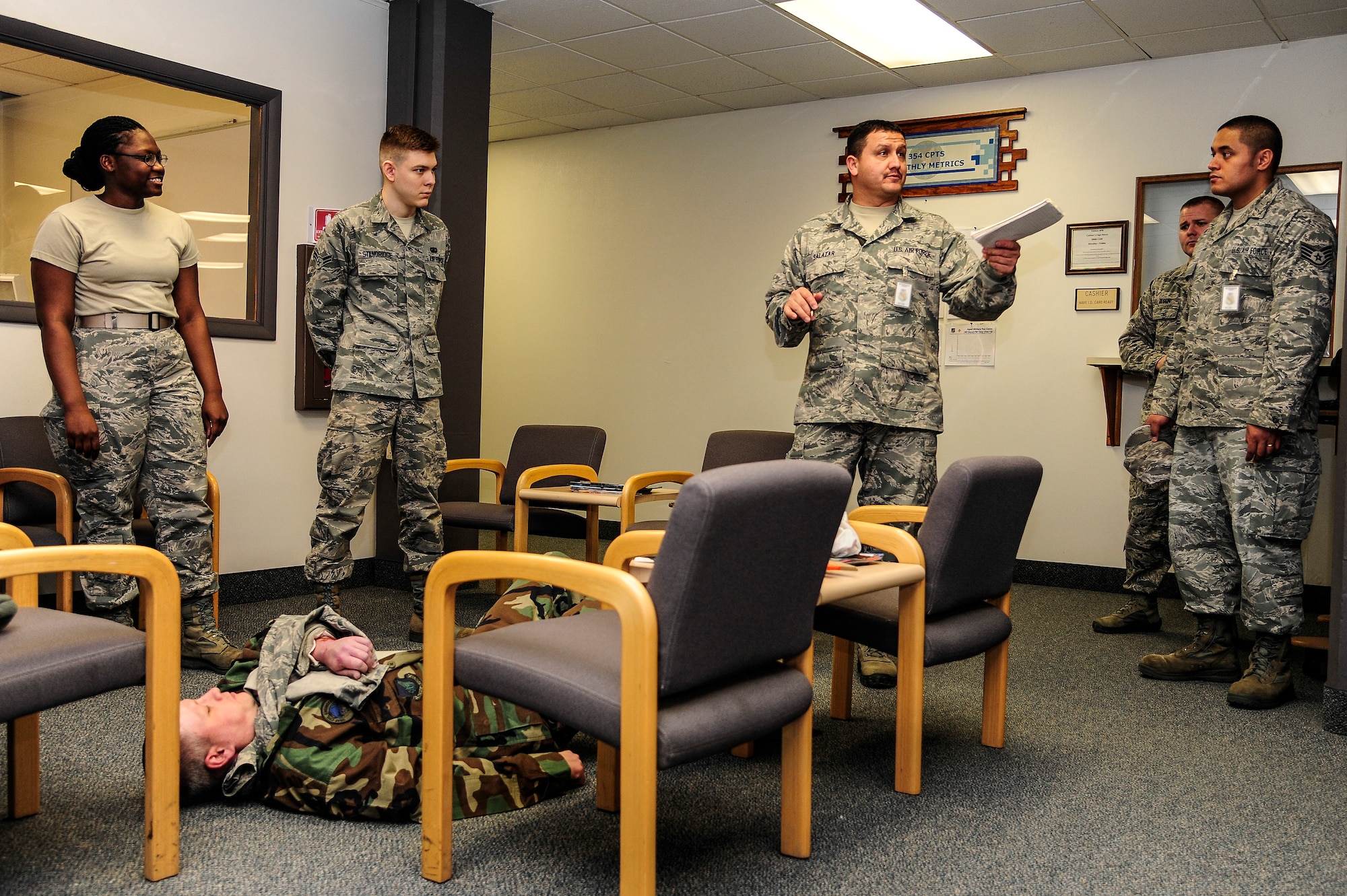 Staff Sgt. Raul Salazar, 354th Medical Group exercise evaluation team member, briefs members of the 354th Comptroller Squadron after a Self-Aid Buddy Care scenario Jan. 28, 2014, Eielson Air Force Base, Alaska. EET members are responsible for the evaluation of the response and reaction of Icemen to certain situations such as SABC. (U.S. Air Force photo by Senior Airman Zachary Perras/Released)