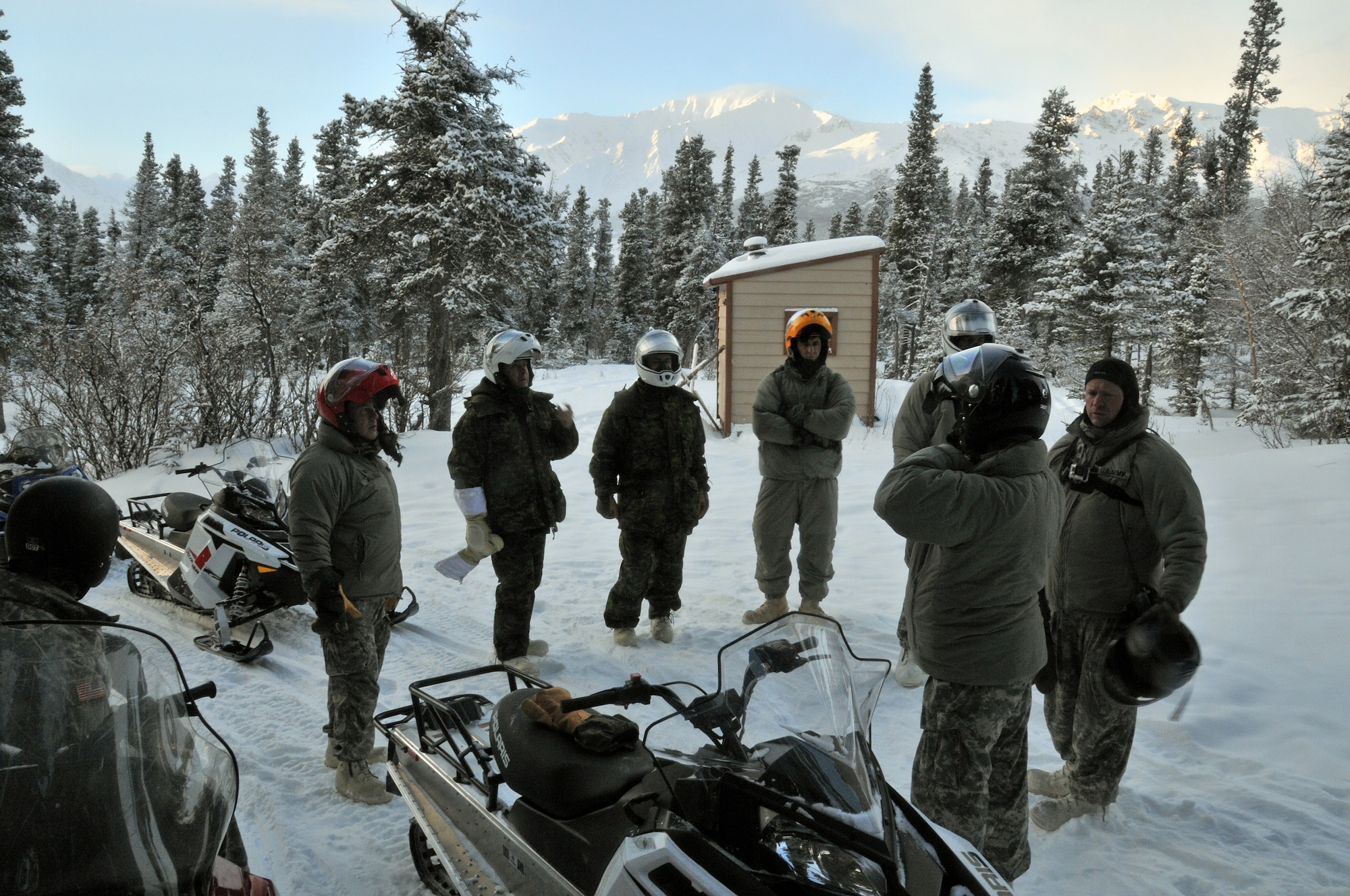 BLACK RAPIDS TRAINING SITE, Alaska— Attendees of an Arctic General Officer/Flag Officer Conference learn capabilities and limitations of snow machines Jan. 10. Alaskan Command/Joint Task Force-Alaska and U.S. Army Alaska hosted a GO/FO Conference Jan. 7-11, which included distinguished guests from the U.S. Air Force, U.S. Army, Alaska National Guard, U.S. Coast Guard and Canadian Forces, to strengthen partnerships, discuss future Arctic challenges and joint capabilities. (U.S. Air Force photo/Tech. Sgt. John Gordinier)