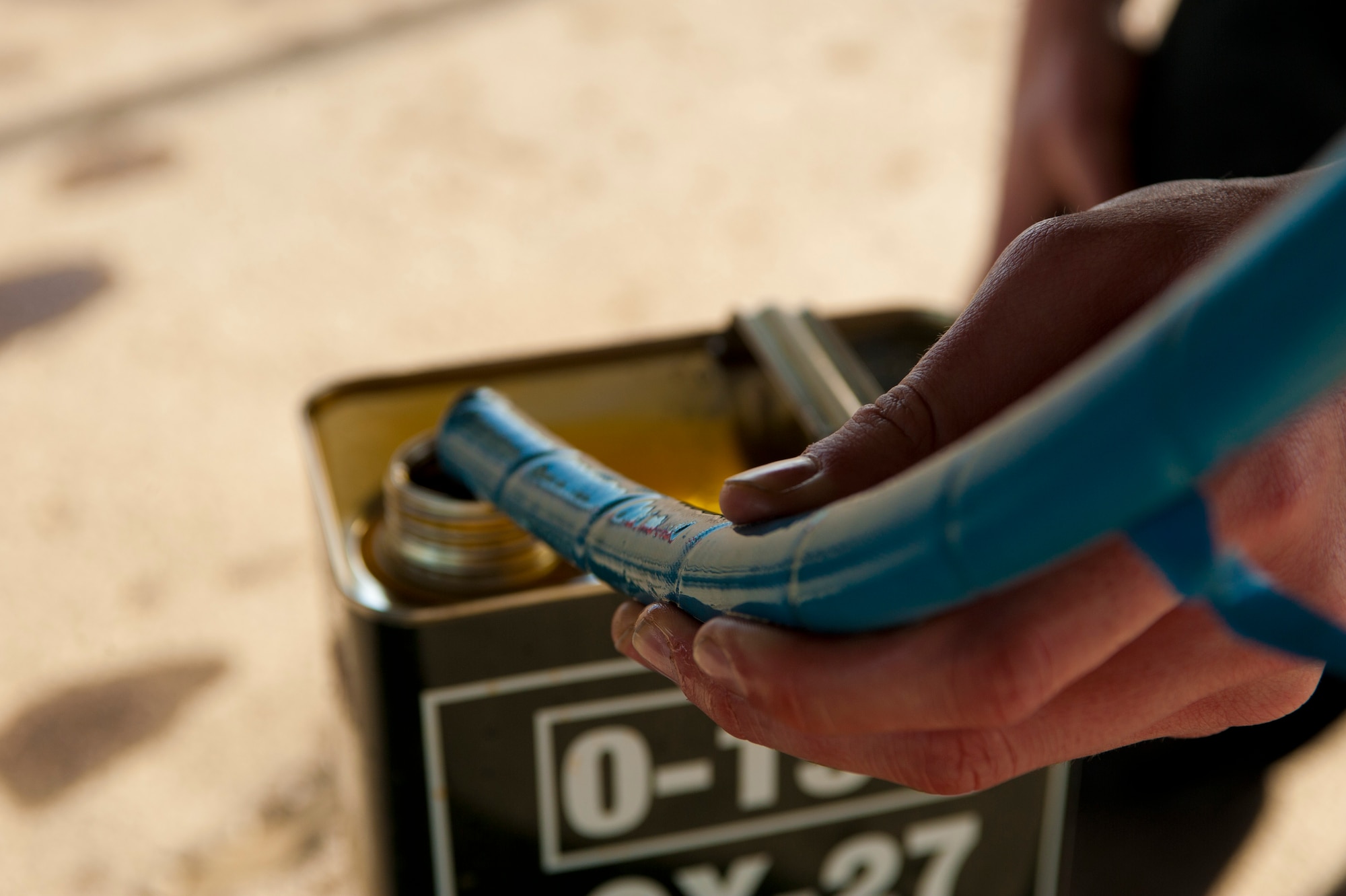 Royal Air Force Senior Air Craftsman Dylan Ness, IX Bomber Squadron aircraft maintenance mechanic, from RAF Marham, United Kingdom, refills engine oil on a Tornado GR4 following a training mission Jan. 28, 2014, at Nellis Air Force Base, Nev. Aircraft maintainers play a vital role in Red Flag by ensuring aircraft are safe and repaired in a timely manner so flight training can continue. (U.S. Air Force photo by Airman 1st Class Joshua Kleinholz)