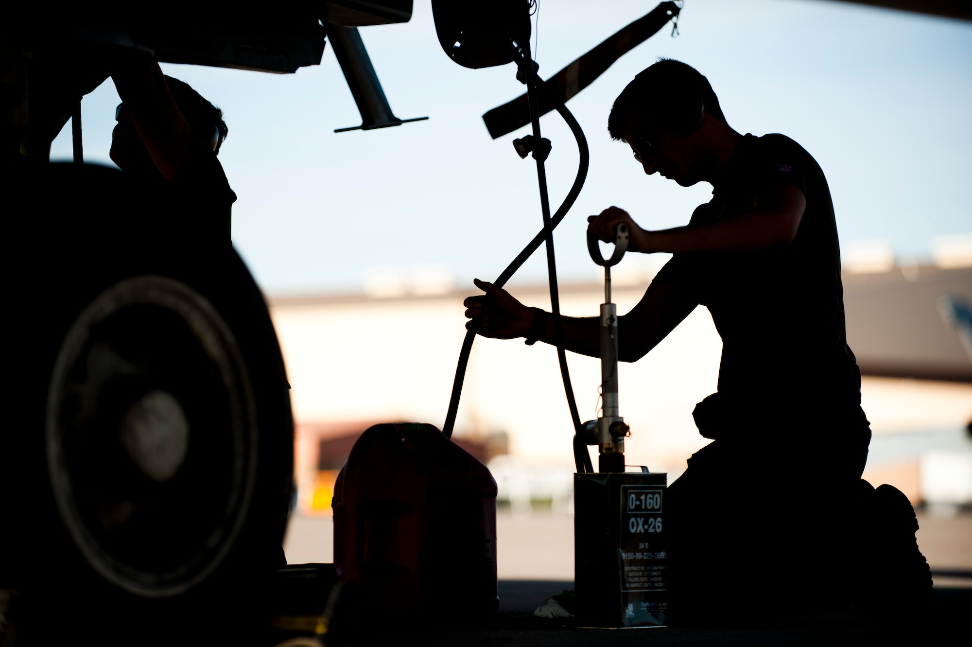 Royal Air Force Senior Air Craftsman Dylan Ness, IX Bomber Squadron aircraft maintenance mechanic from RAF Marham, United Kingdom, refills engine oil on a Tornado GR4 following a training mission Jan. 28, 2014, at Nellis Air Force Base, Nev. The GR4 Tornado is one of two airframes being flown by the British at Red Flag, and has been successfully deployed in operational theatres since 1990. (U.S. Air Force photo by Airman 1st Class Joshua Kleinholz)