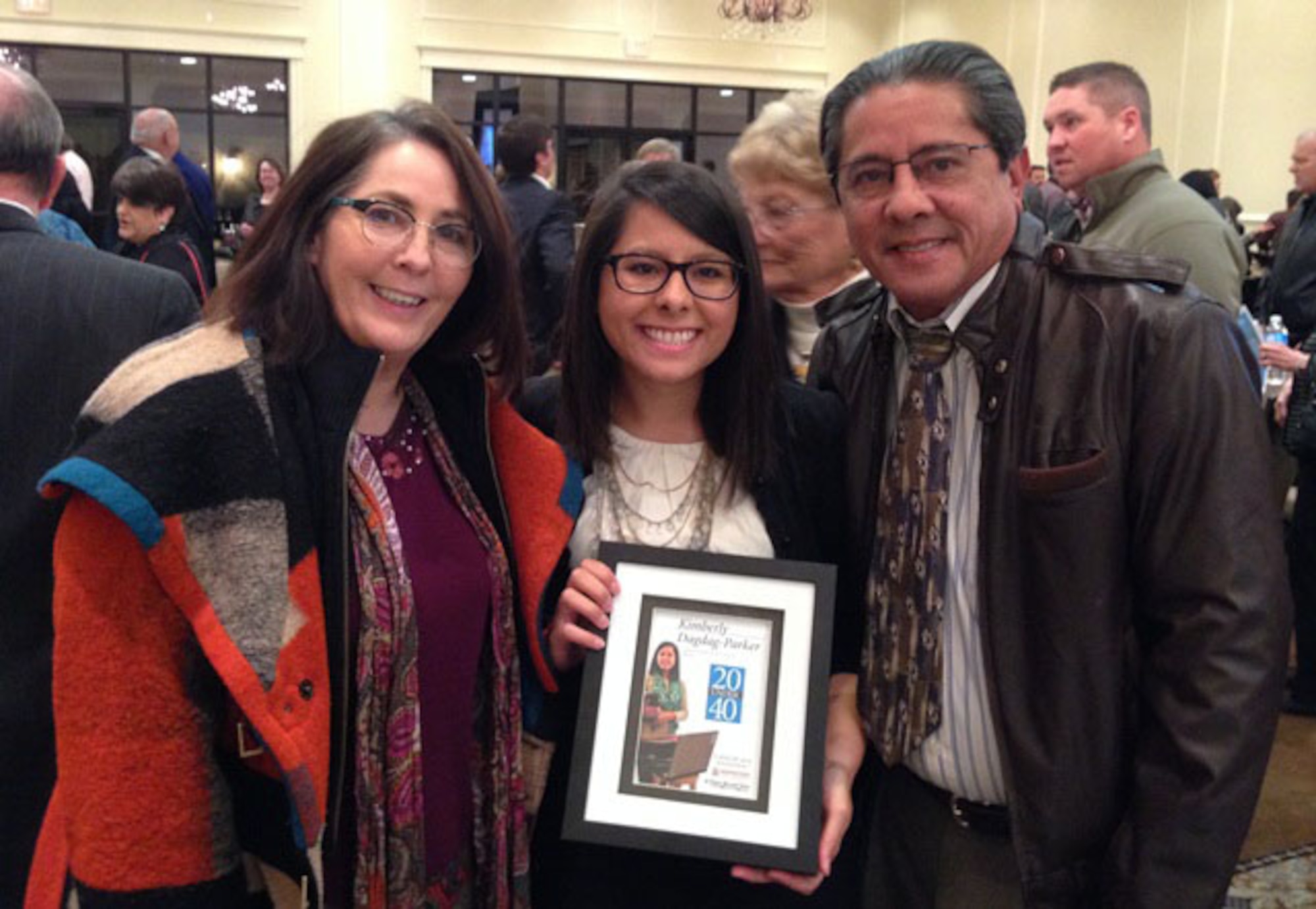 Kimberly Dagdag-Parker (center) with mom Teresa Dagdag and dad Luis Dagdag during the induction ceremony for the 2013 class of "20 Under 40" leaders Jan. 28 at the Wellington Banquet Center in Wichita Falls, Texas.  Dagdag-Parker was the only selectee from Sheppard Air Force Base as one of the Texhoma area's best and brightest leaders of tomorrow. (U.S. Air Force courtesy photo)