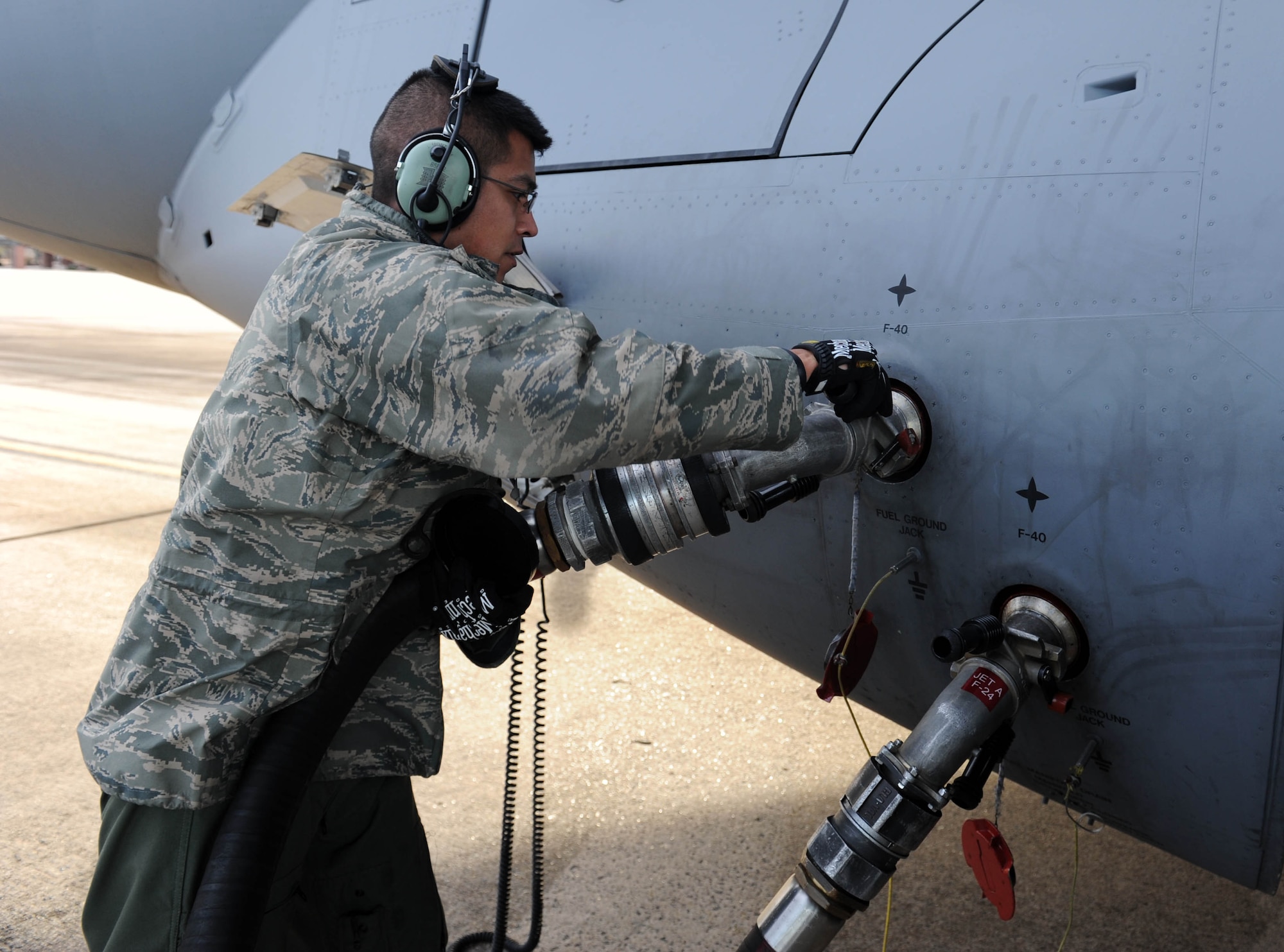 Staff Sgt. John Montoya, a 736th Aircraft Maintenance Squadron crew chief assigned to Dover Air Force Base, Del., attaches a fuel hose to a C-17 Jan. 16, 2014, at Little Rock Air Force Base, Ark. The 19th LRS fuels all planes stationed at, or visiting The Rock. (U.S. Air Force photo by Staff Sgt. Jessica Condit)