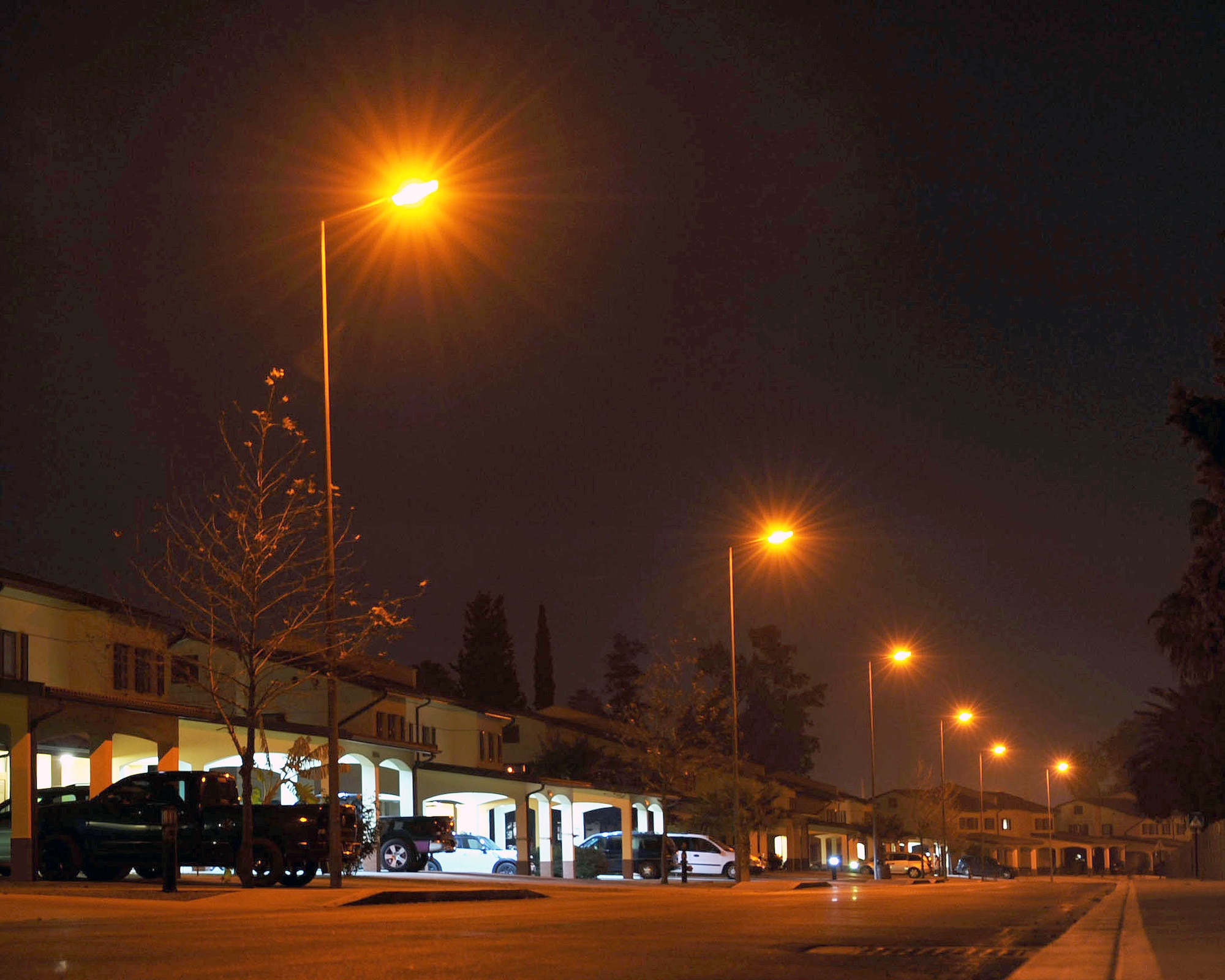 INCIRLIK AIR BASE, Turkey -- A row of homes in Eagle Housing are lit by streetlamps and door lights Jan. 13, 2014, at Incirlik Air Base, Turkey. Saving energy by turning off outdoor lights during the day is one responsibility of residents living in accompanied housing. (U.S. Air Force photo by Senior Airman Chase Hedrick/Released)