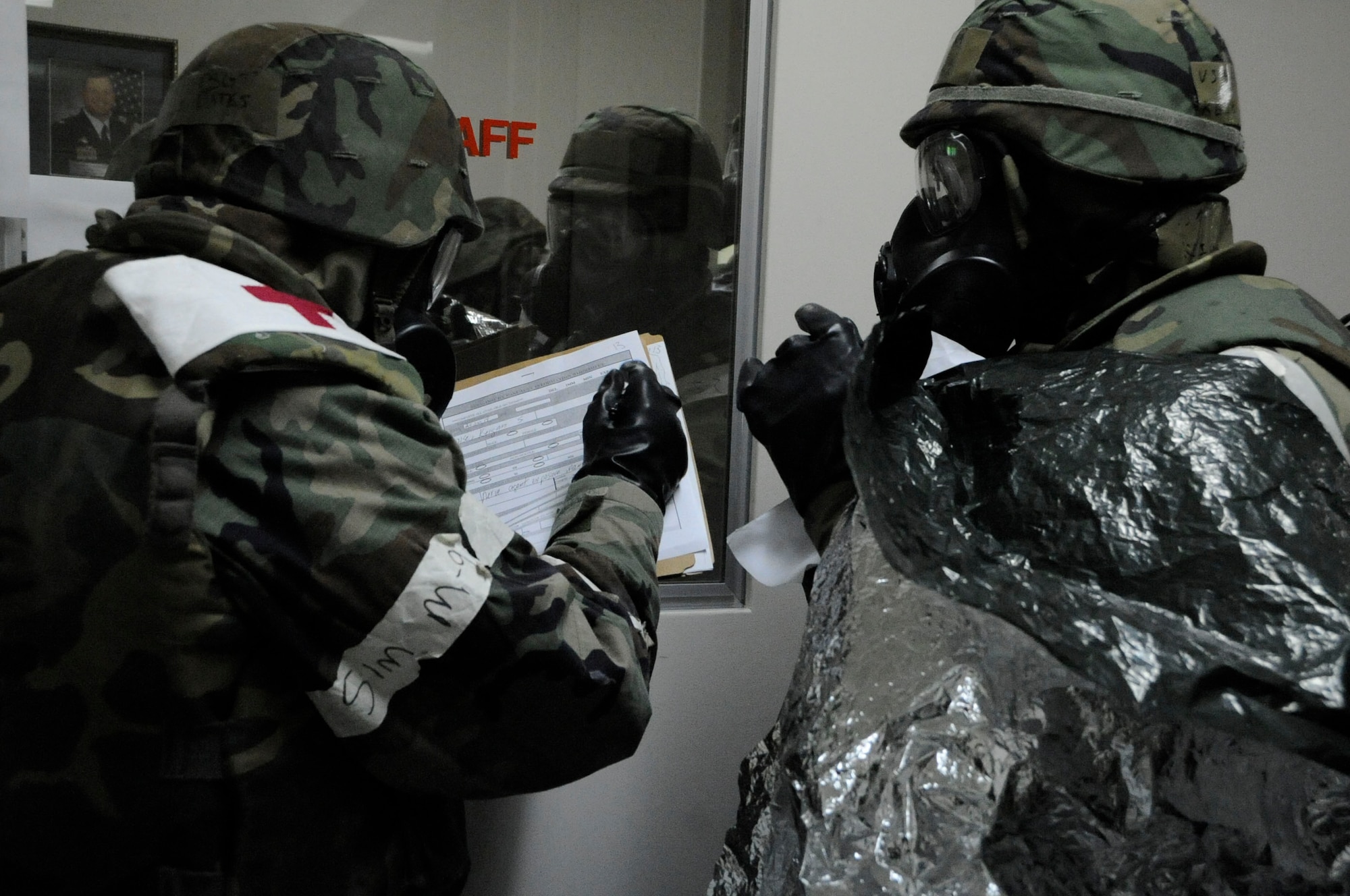 An Airman from the 35th Medical Group prepares an Airman for the decontamination process during an operational readiness exercise at Misawa Air Base, Japan, Jan. 28, 2014. Once patients are decontaminated, they are admitted into the hospital’s triage unit. (U.S. Air Force photo/Airman 1st Class Patrick S. Ciccarone)