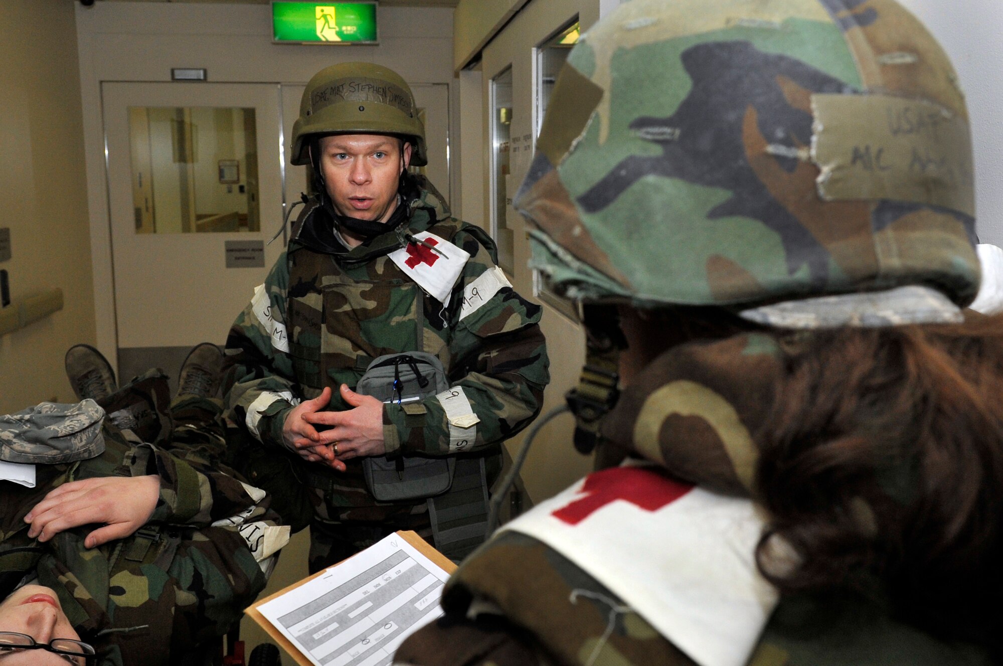 Maj. Steven Simpson, 35th Aerospace Medicine Squadron optometry flight commander, works with Airman 1st Class Aubrey George, 35th Medical Support Squadron outpatient records, to place a patient in their proper category during an operational readiness exercise at Misawa Air Base, Japan, Jan. 28, 2014. Patients are placed in different categories when they come in for care, which includes minor and major injuries, mental health issues and patients who have been contaminated. (U.S. Air Force photo by Airman 1st Class Zachary Kee)