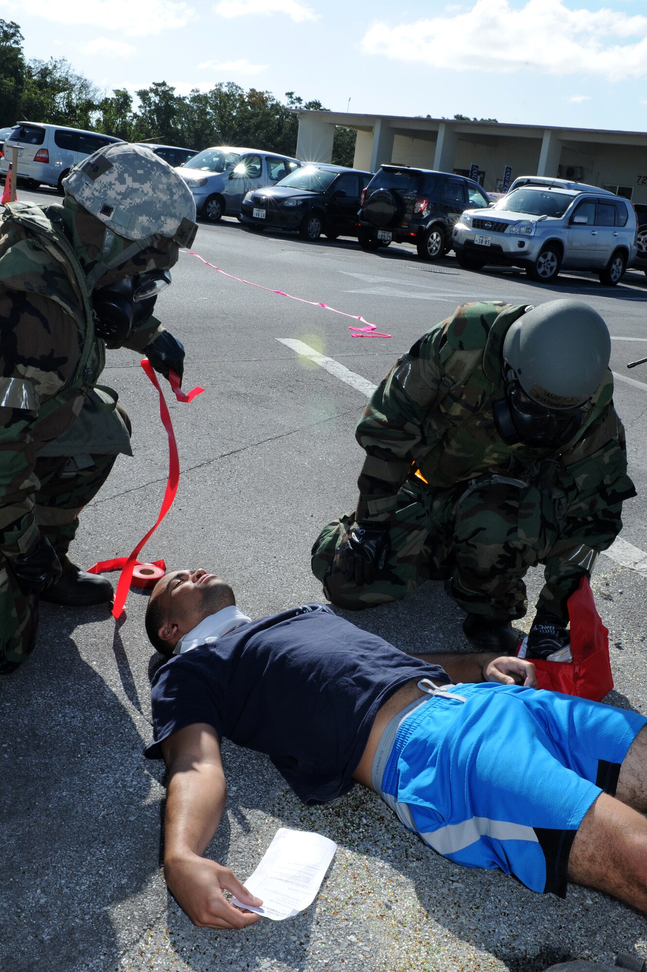 U.S. Air Force Senior Airmen Devonte Edmond and Anthony Romero, both assigned to the 18th Force Support Squadron Military Personnel Section, treat a victim for shock during a simulated mass casualty inject for a Mission Focused Exercise on Kadena Air Base, Japan, Jan. 29, 2014. MFEs are designed to test Airmen on a variety of survive and operate scenarios such as self-aid and buddy care, in which Airmen are tasked to perform basic medical techniques while awaiting medical personnel to arrive on scene. (U.S. Air Force photo by Airman 1st Class Hailey R. Staker)