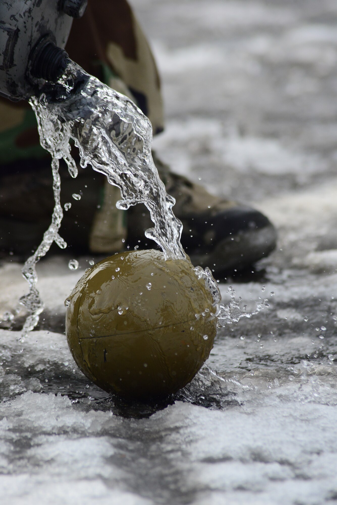 U.S. Air Force Airman 1st Class Anthony Donelan, 35th Civil Engineer Squadron Explosive Ordnance Disposal technician, pours bleach on an unexploded ordnance decontaminating it during an operational readiness exercise on Misawa Air Base, Japan, Jan. 24, 2014. When EOD responds to a chemical attack UXO notification they come prepared with bleach and water to decontaminate the ordnance prior to removing it from the affected area. (U.S. Air Force photo/Tech. Sgt. April Quintanilla))
