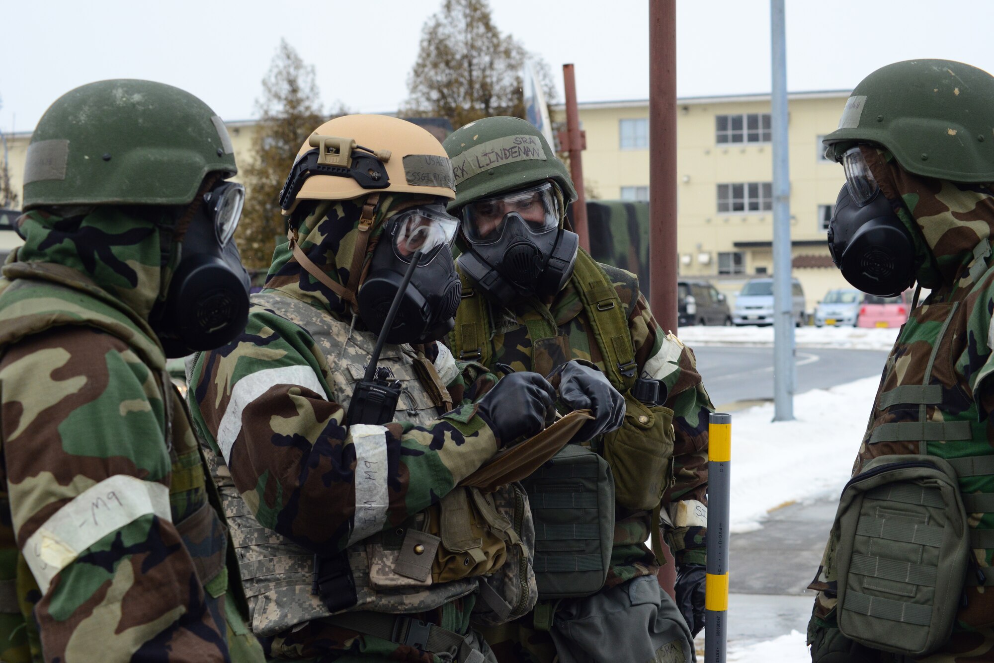 U.S. Air Force Staff Sgt. Ryan Johnson, 35th Civil Engineer Squadron Explosive Ordnance Disposal team lead, gathers information from the 35th Communication Squadron post reconnaissance team about the discovered unexploded ordnance. EOD gathers as much information as possible from the PAR teams in regards to the discovered UXOs to help clear the danger zone. (U.S. Air Force photo/Tech. Sgt. April Quintanilla)