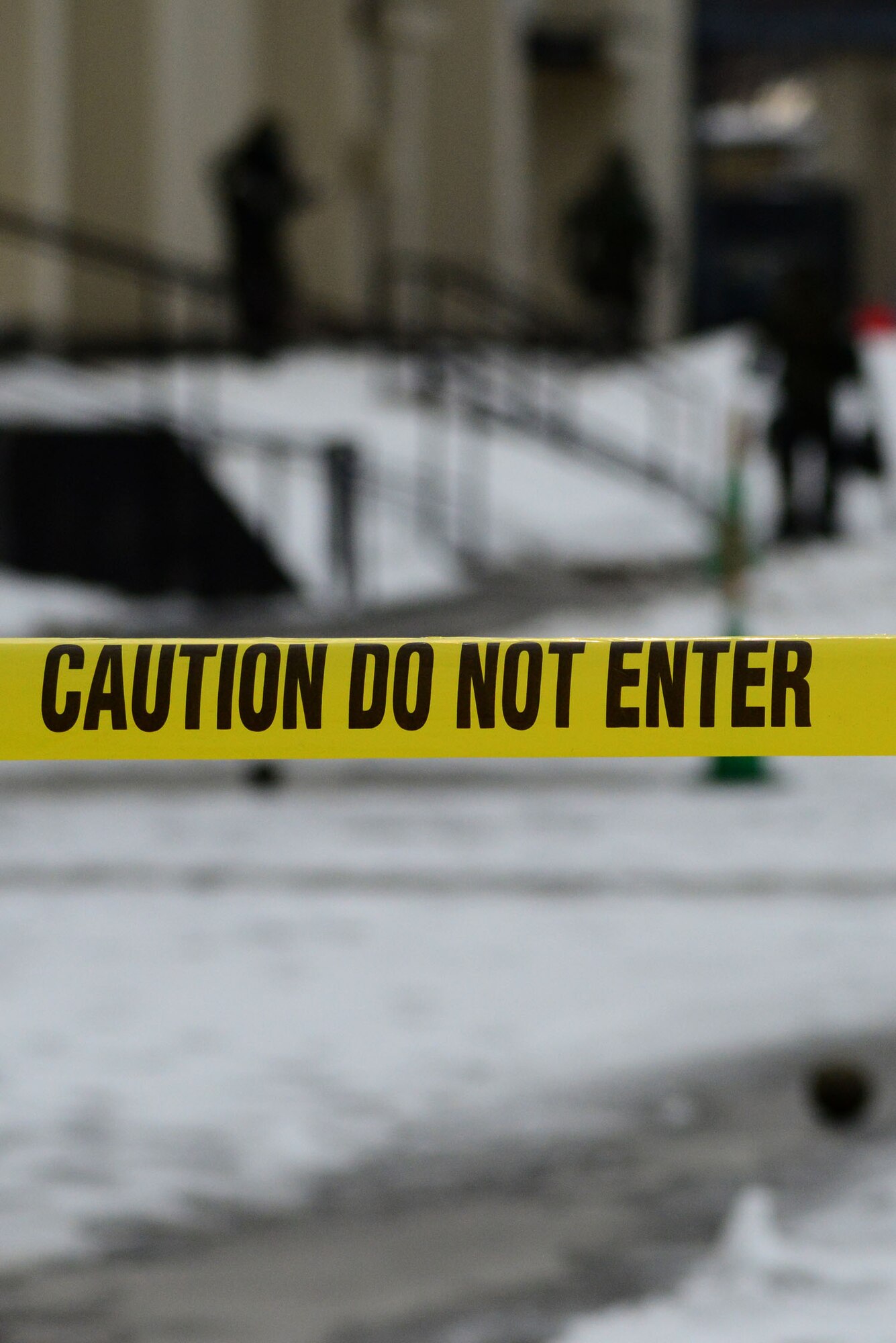 After discovering an unexploded ordnance during an operational readiness exercise on Misawa Air Base, Japan, Jan. 28, 2014, the 35th Communications Squadron's post attack reconnaissance team  setup a 500 foot cordon. The cordon prevents unauthorized personnel from entering the danger zone while the members wait for the Explosive Ordnance Disposal team to arrive. (U.S. Air Force photo/Tech. Sgt. April Quintanilla)