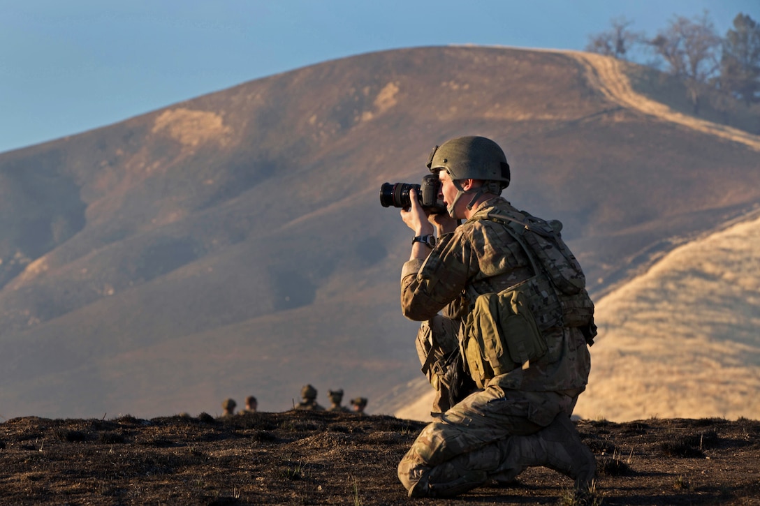 Army Spc. Steven Hitchcock photographs Army Rangers during a mission on Fort Hunter Liggett, Calif., Jan. 22, 2014. Hitchcock, a combat photographer, is assigned to 55th Signal Company Combat Camera, Fort Meade, Md.