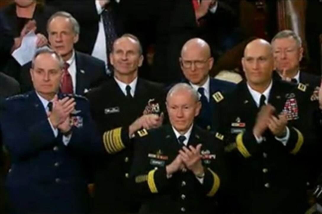 Army Gen. Martin E. Dempsey, chairman of the Joint Chiefs of Staff, and other defense leaders applaud Army Sgt. 1st Class Cory Remsburg, who was cited in President Barack Obama's State of the Union address at the U.S. Capitol, Jan. 28, 2014. Remsburg was wounded by a bomb blast in Afghanistan on his 10th deployment.