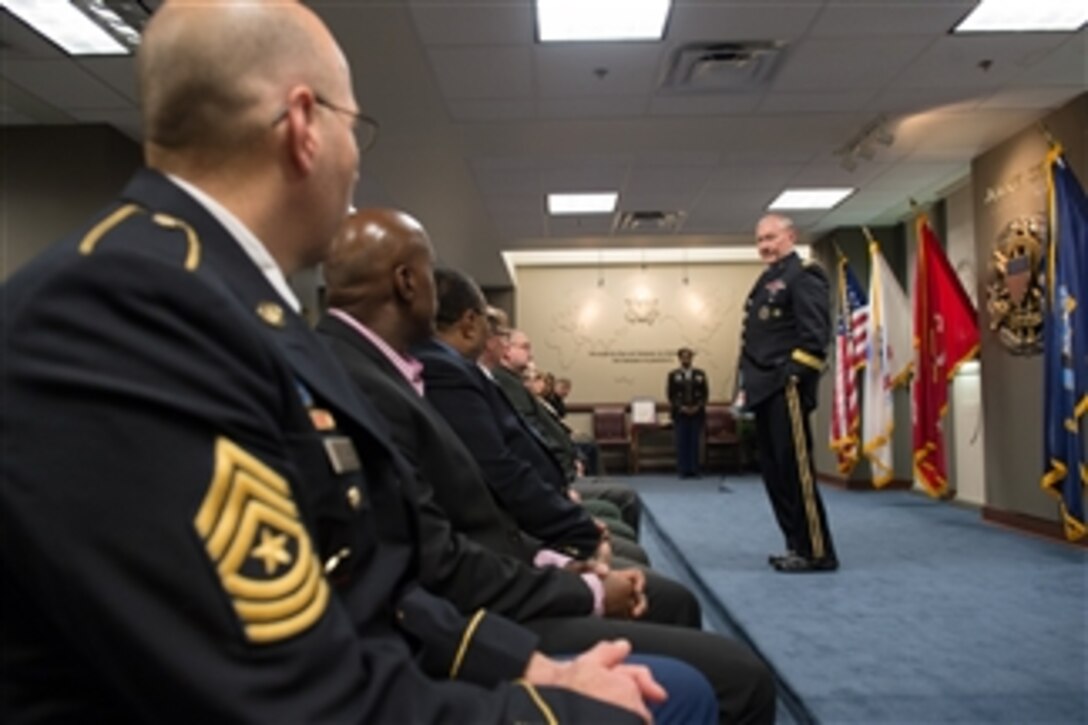 Army Gen. Martin E. Dempsey, chairman of the Joint Chiefs of Staff, speaks during a ceremony for retired Army Pfc. Mark A. Deville, center front, and his former platoon members to present Deville with a Silver Star, the nation's third highest military award, for his actions in Korea 30 years ago, at the Pentagon, Jan. 28, 2014.