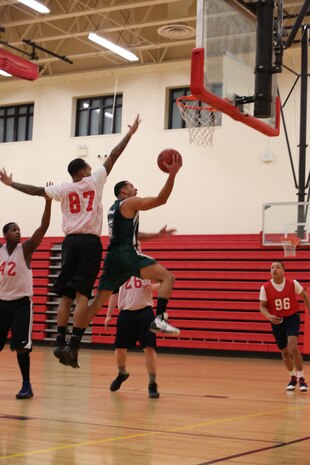Cpl. Jonathan Morales, a player for the Marine Helicopter Squadron One intramural basketball team, goes for a layup during the HMX-1 versus Officer Candidate School game at Barber Physical Activity Center on Jan. 22, 2014. HMX-1 won with a score of 41 to 34.