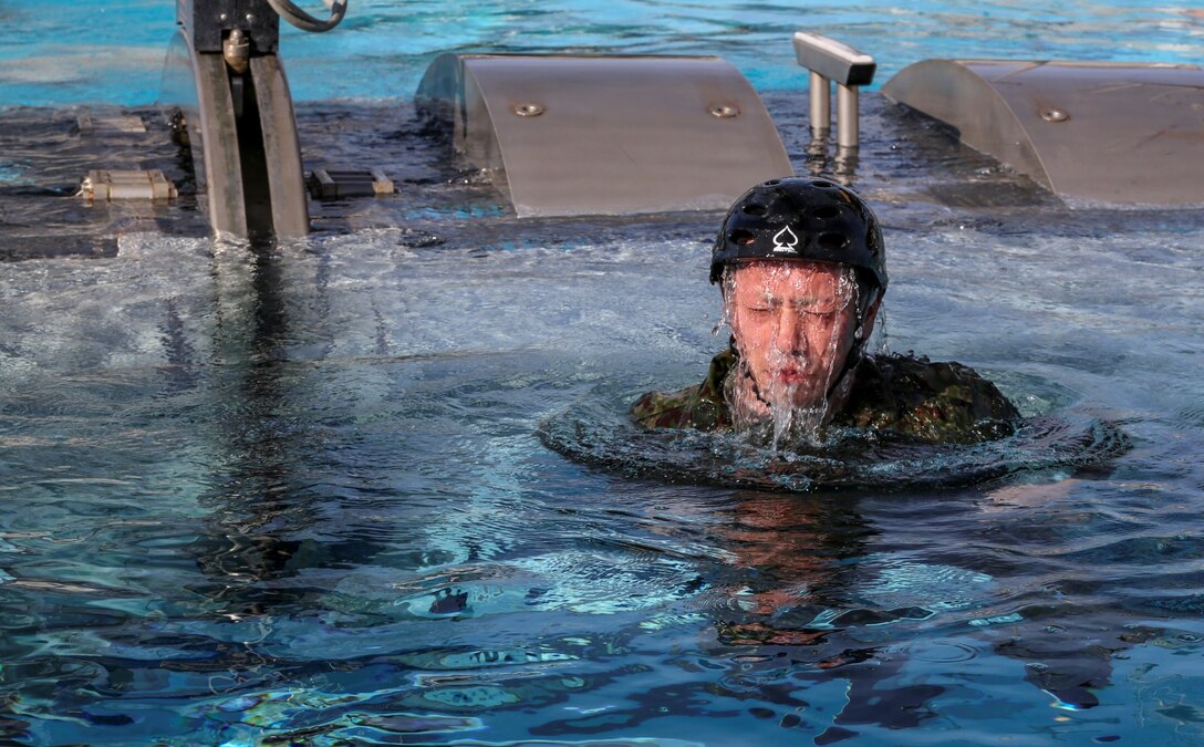 A soldier with the Japan Ground Self-Defense Force emerges from a Modular Amphibious Egress Trainer while conducting Underwater Egress training during Exercise Iron Fist 2014 aboard Camp Pendleton, Calif., Jan. 23, 2014. Iron Fist is an amphibious exercise that brings together Marines and sailors from the 15th Marine Expeditionary Unit, other I Marine Expeditionary Force units, and soldiers from the JGSDF, to promote military interoperability and hone individual and small-unit skills through challenging, complex and realistic training. (U.S. Marine Corps photo by Cpl. Emmanuel Ramos/Released)