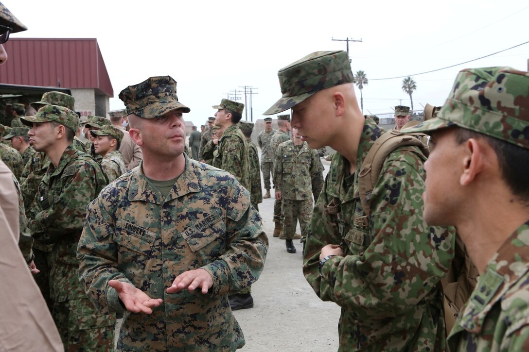 U.S. Marine Gunnery Sgt. Shawn C. Souders, 3rd Assault Amphibian Battalion, explains the tactical advantages of the AAV-7 Amphibious Assault Vehicle to soldiers with the Japan Ground Self-Defense Force during Exercise Iron Fist 2014 aboard Camp Pendleton, Calif., Jan. 24, 2014. Iron Fist is an amphibious exercise that brings together Marines and sailors from the 15th Marine Expeditionary Unit, other I Marine Expeditionary Force units, and soldiers from the JGSDF, to promote military interoperability and hone individual and small-unit skills through challenging, complex and realistic training. (U.S. Marine Corps photo by Sgt. Jamean R. Berry/Released)