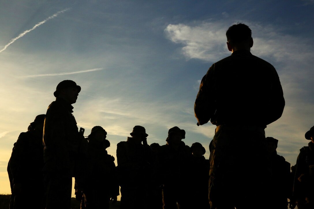 U.S. Marines with 1st Air Naval Gunfire Liaison Company and soldiers from the Japan Ground Self-Defense Force stand at the half-way point of a hike during Exercise Iron Fist 2014 aboard Camp Pendleton, Calif., Jan. 28, 2014. Iron Fist 2014 is an amphibious exercise that brings together Marines and sailors from the 15th Marine Expeditionary Unit, other I Marine Expeditionary Force units, and soldiers from the JGSDF, to promote military interoperability and hone individual and small-unit skills through challenging, complex and realistic training. (U.S. Marine Corps photo by Lance Cpl. Anna K. Albrecht/Released)