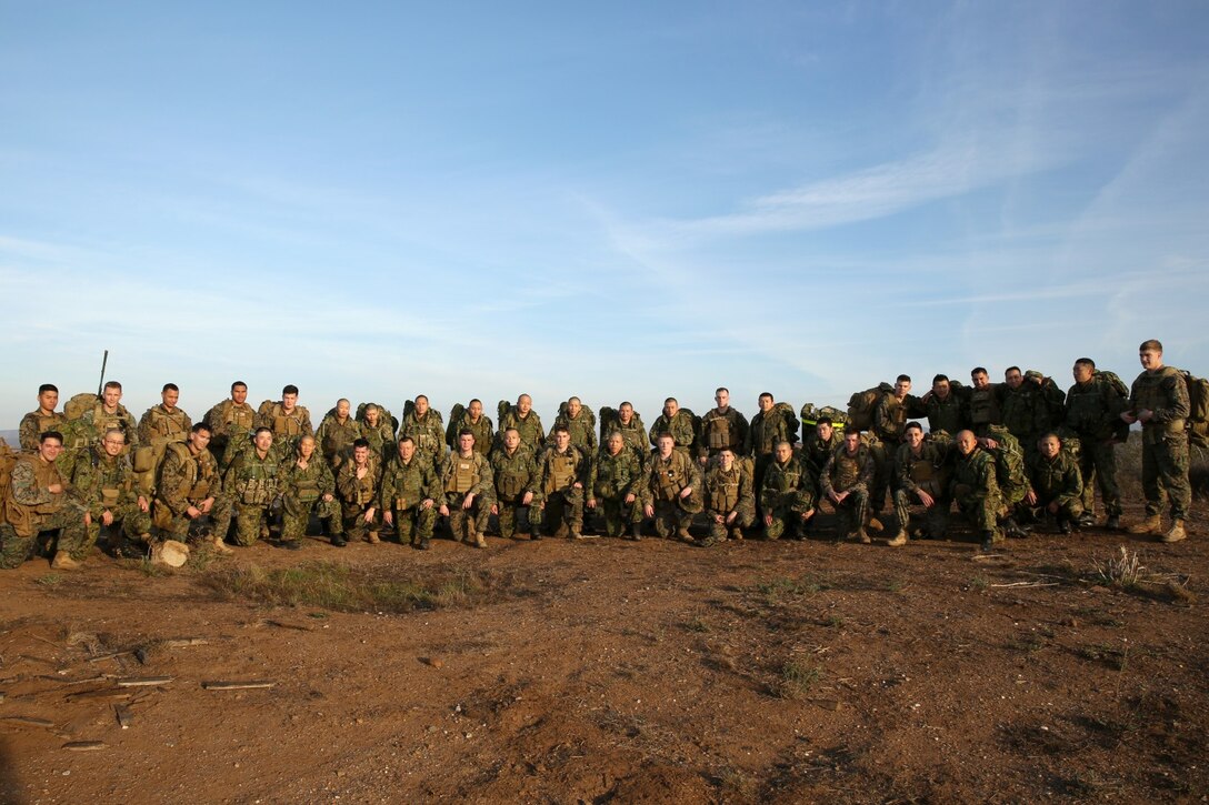 U.S. Marines with 1st Air Naval Gunfire Liaison Company and soldiers from the Japan Ground Self-Defense Force stand at the half-way point of a hike during Exercise Iron Fist 2014 aboard Camp Pendleton, Calif., Jan. 28, 2014. Iron Fist 2014 is an amphibious exercise that brings together Marines and sailors from the 15th Marine Expeditionary Unit, other I Marine Expeditionary Force units, and soldiers from the JGSDF, to promote military interoperability and hone individual and small-unit skills through challenging, complex and realistic training. (U.S. Marine Corps photo by Lance Cpl. Anna K. Albrecht/Released)