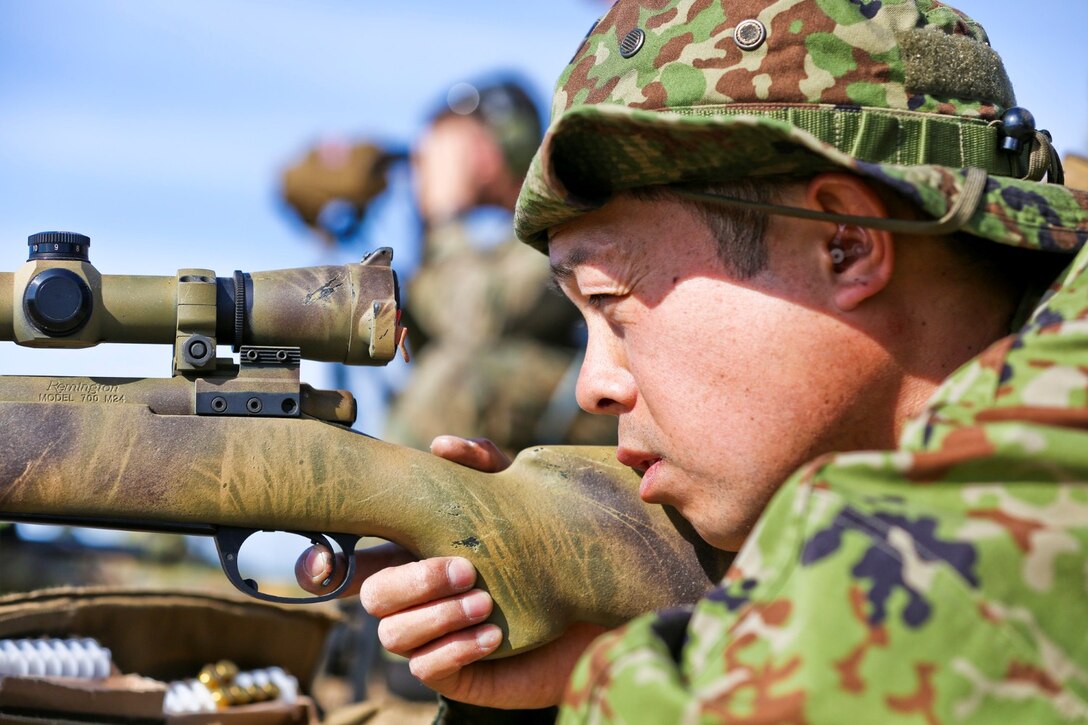 A soldier from the Japan Ground Self-Defense Force sights into his target before engaging in a shooting drill while conducting scout sniper training during Exercise Iron Fist 2014 aboard Camp Pendleton, Calif., Jan. 29, 2014. Iron Fist is an amphibious exercise that brings together Marines and sailors from the 15th Marine Expeditionary Unit, other I Marine Expeditionary Force units, and soldiers from the JGSDF, to promote military interoperability and hone individual and small-unit skills through challenging, complex and realistic training. (U.S. Marine Corps photo by Lance Cpl. Ricardo Hurtado/Released)