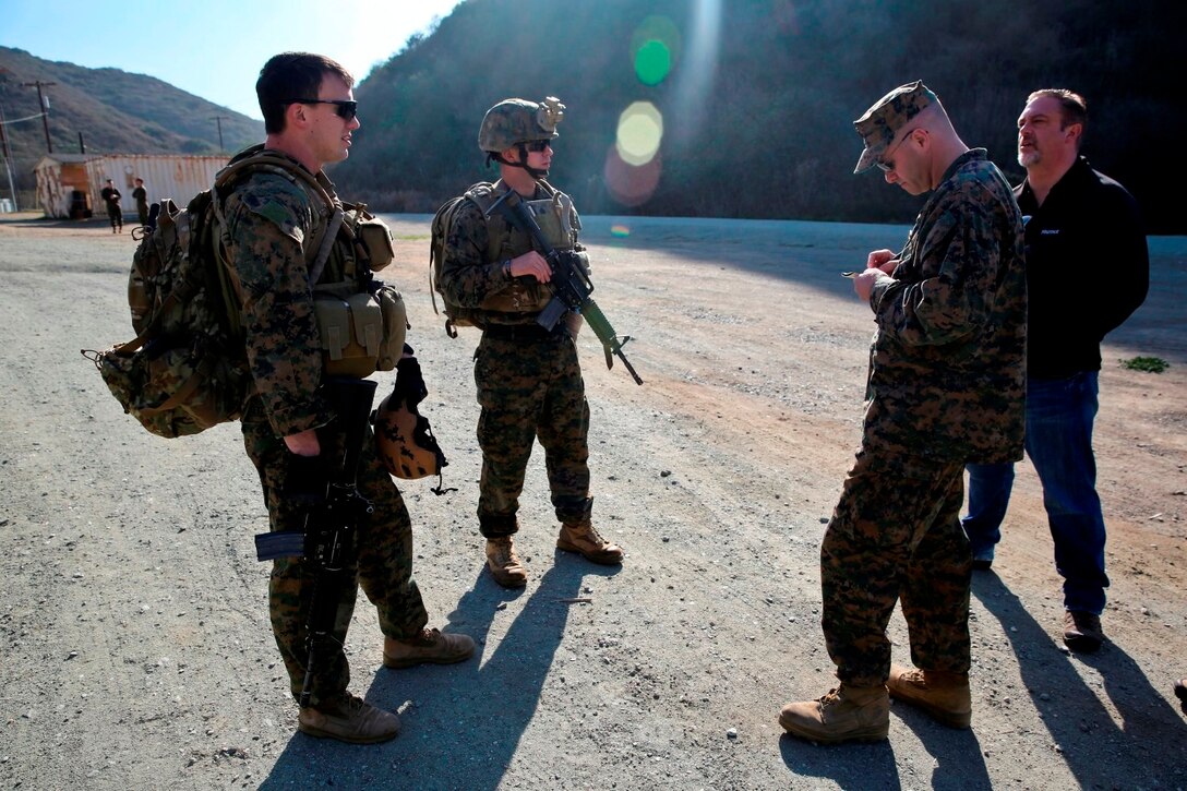 Lt. Cmdr. David Gribben, project head of expeditionary medicine with Marine Corps Warfighting Laboratory, from Bristol, Va., takes notes from corpsmen during operational testing of the Tempus Pro, a tactical telemedicine device, over two days of trials aboard Camp Pendleton, Calif., Jan. 22-23. The Tempus Pro attaches to the patient and broadcasts their vital signs back to a battalion aid station or aiding physician so that they can instruct and help the corpsman.
